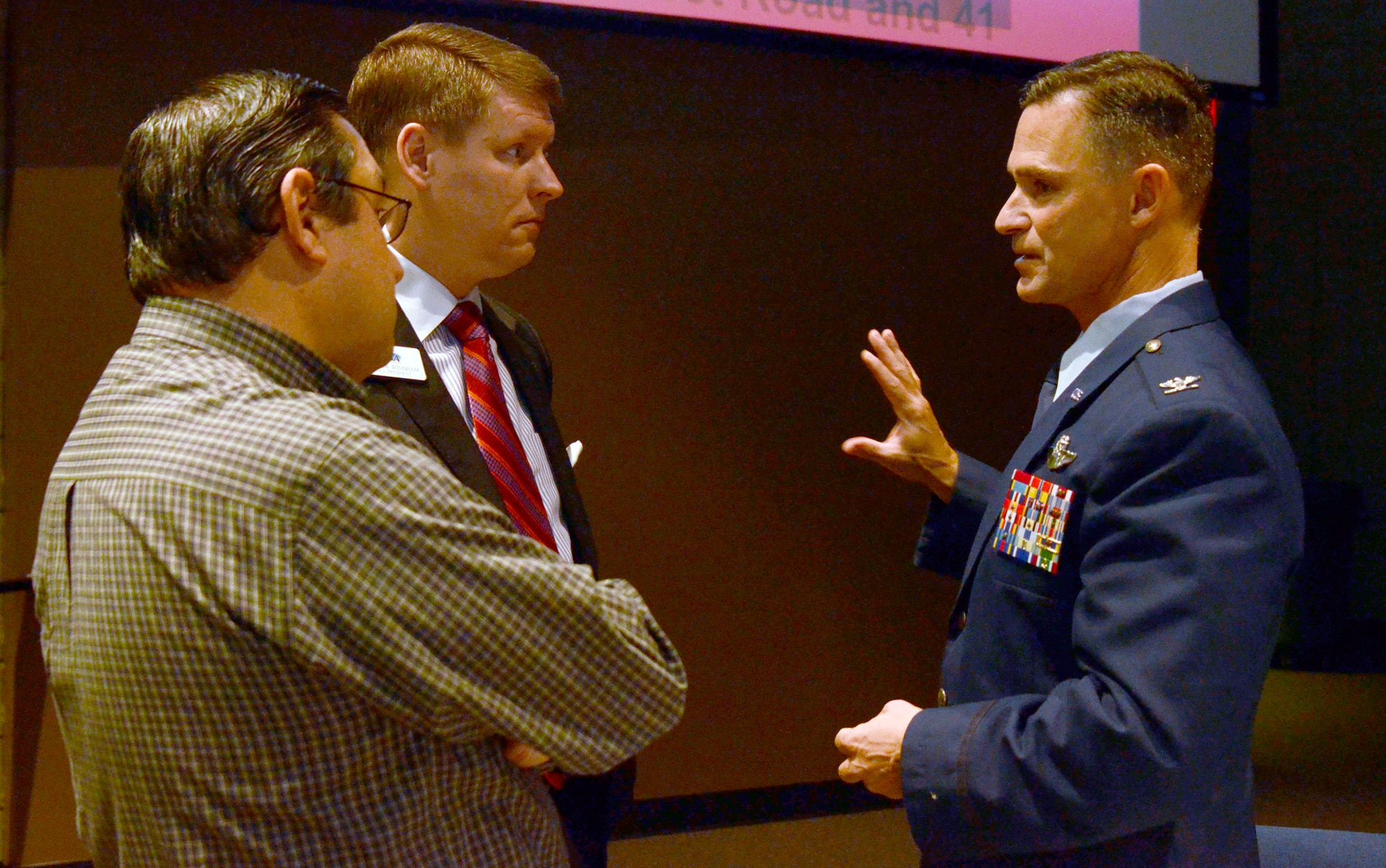 Col. Brett Clark, 94th Airlift Wing commander, visits with Mark Zangari, from Dollar Wise Cartridge, L.L.C and Acworth Business Association executive director of membership; and Andrew Windham, College Planning Institute vice president, while attending the Acworth Business Association monthly meeting in Acworth, Ga. Nov. 6, 2014. (U.S. Air Force photo by Don Peek/Released)