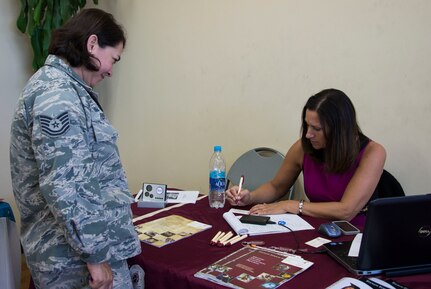 U.S. Air Force Tech. Sgt. Gloria Hofilena, Army Forces Battalion supply sergeant, receives information about the master degree programs offered at Thomas Edison State College from Patti Hunt, Associate Director for Military and Veteran Education, during the Education Fair at Soto Cano Air Base, Honduras, Nov. 5, 2014.  The Education Fair was provided by the Army Support Activity to give members information on degree plans, degree completion, as well as classroom and distance learning options. (U.S. Air Force photo/Tech. Sgt. Heather Redman)