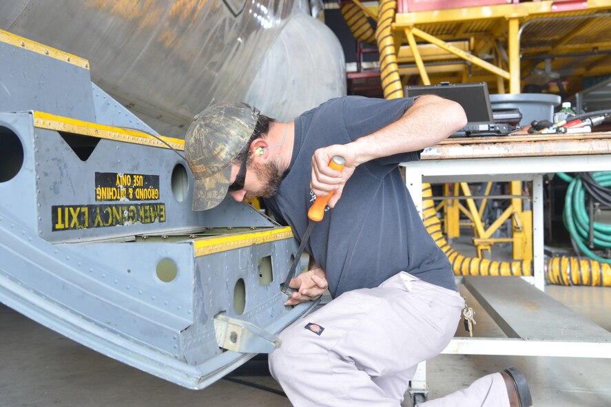 Nathan Horn, C-130 Functional Test Flight aircraft worker, repairs a door latch on a C-130. U.S. Air Force photo by Ray Crayton
