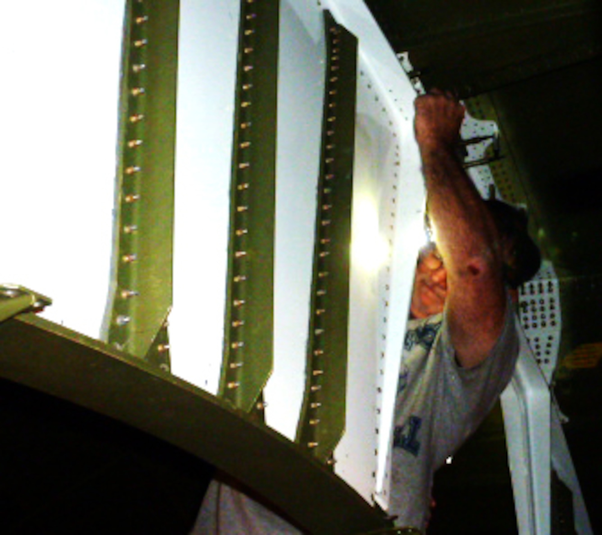 David McLemore, sheet metal mechanic, installs web plates on the Batman fitting. The fitting gets its nickname due to its resemblance to the cowl worn by the fictional character. U.S. Air Force photo by Isaac Cruz
