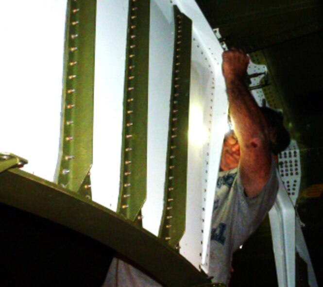 David McLemore, sheet metal mechanic, installs web plates on the Batman fitting. The fitting gets its nickname due to its resemblance to the cowl worn by the fictional character. (U.S. Air Force photo/Isaac Cruz)
