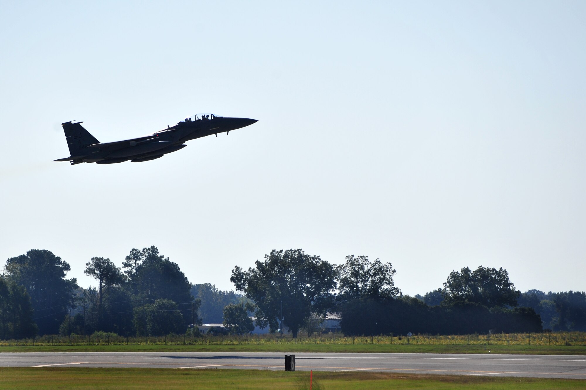An F-15E Strike Eagle assigned to the 4th Fighter Wing at Seymour Johnson Air Force Base, North Carolina, takes off Oct. 11, 2014, on its way to Nellis Air Force Base, Nevada, in support of the U.S. Air Force Weapons School’s Weapons Instructor Course. Airmen and aircraft assigned to the 4th FW recently returned home from Nellis AFB, where they were tasked with enhancing the F-15E Strike Eagle capability and providing additional air support for the students attending the Weapons School’s Weapons Instructor Course. (U.S. Air Force photo/Senior Airman John Nieves Camacho) 