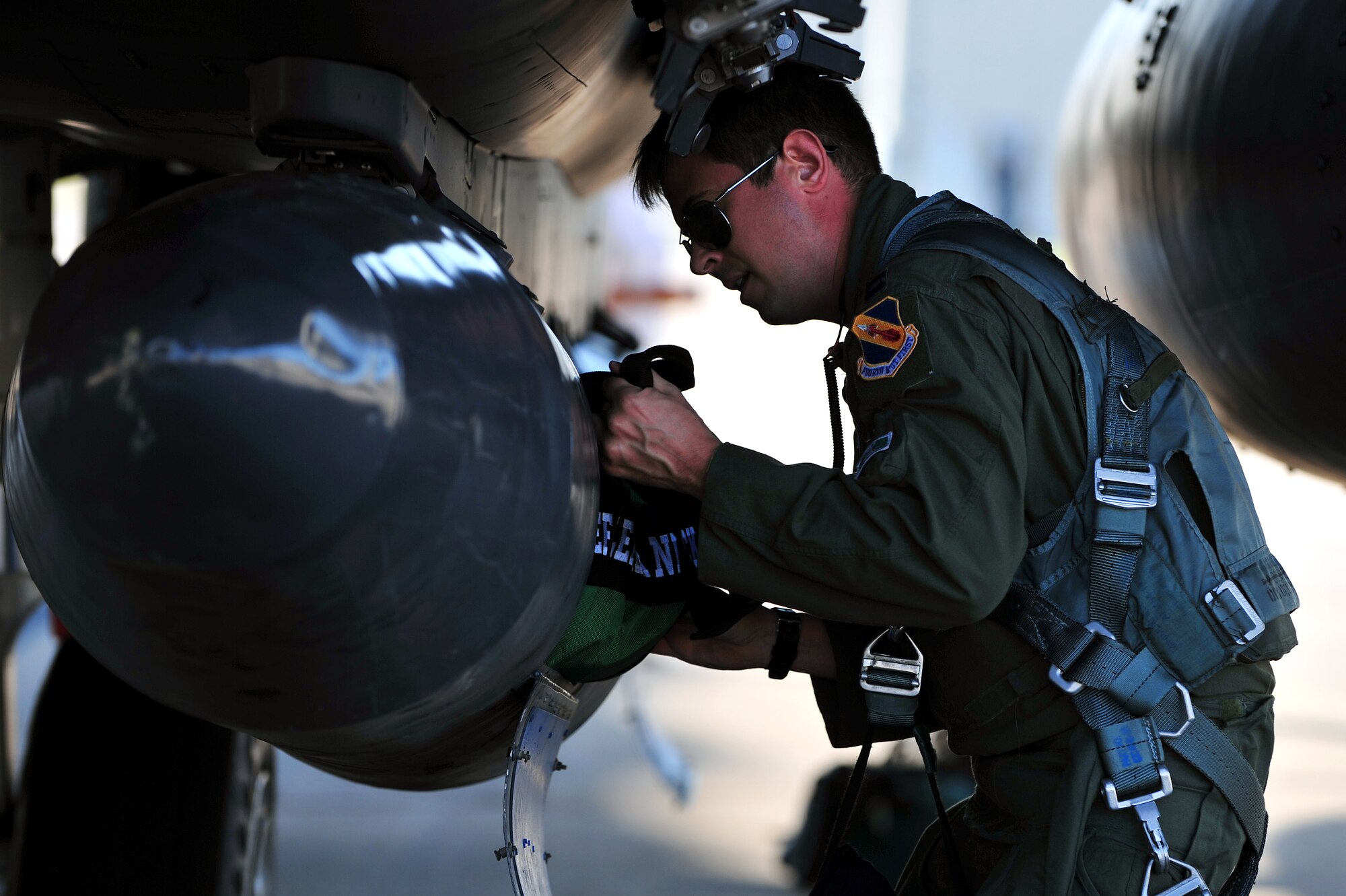 Capt. Erik Spear, 335th Fighter Squadron weapons systems officer, prepares his F-15E Strike Eagle at Seymour Johnson Air Force Base, North Carolina, Oct. 11, 2014, before heading to Nellis Air Force Base, Nevada, in support of the U.S. Air Force Weapons School’s Weapons Instructor Course. Airmen and aircraft assigned to the 4th Fighter Wing out of Seymour Johnson AFB recently returned home from Nellis AFB, where they were tasked with enhancing the F-15E Strike Eagle capability and providing additional air support for the students attending the Weapons School’s Weapons Instructor Course. (U.S. Air Force photo/Senior Airman John Nieves Camacho)