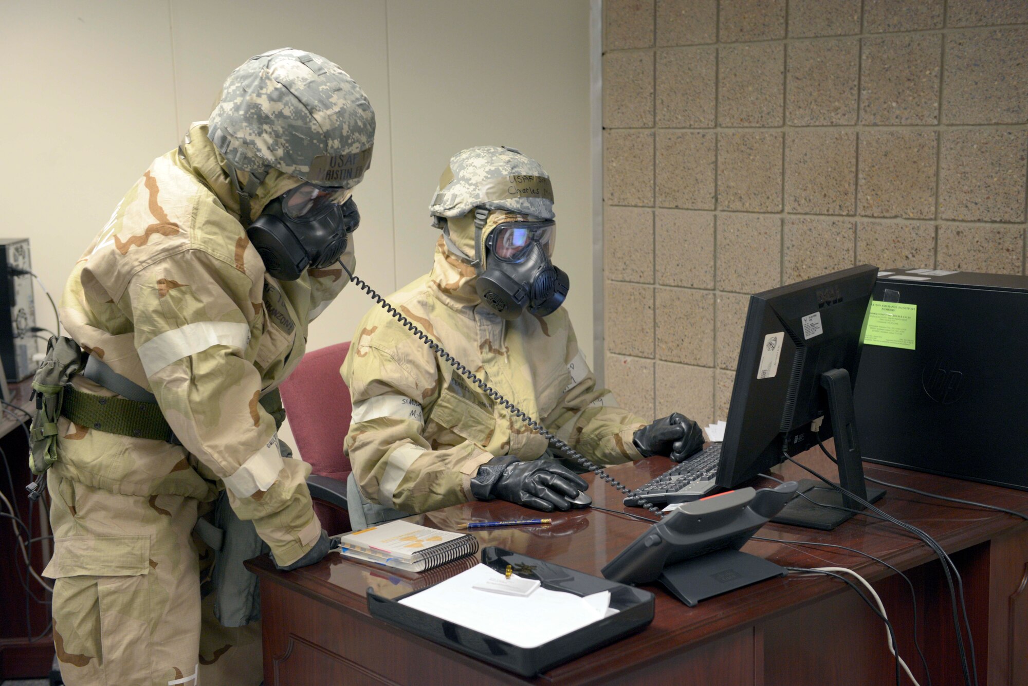 Members of the 934th Airlift Wing perform duties while in Mission oriented Protective Posture gear as part of an exercise at the November UTA. (Air Force Photo/Paul Zadach)
