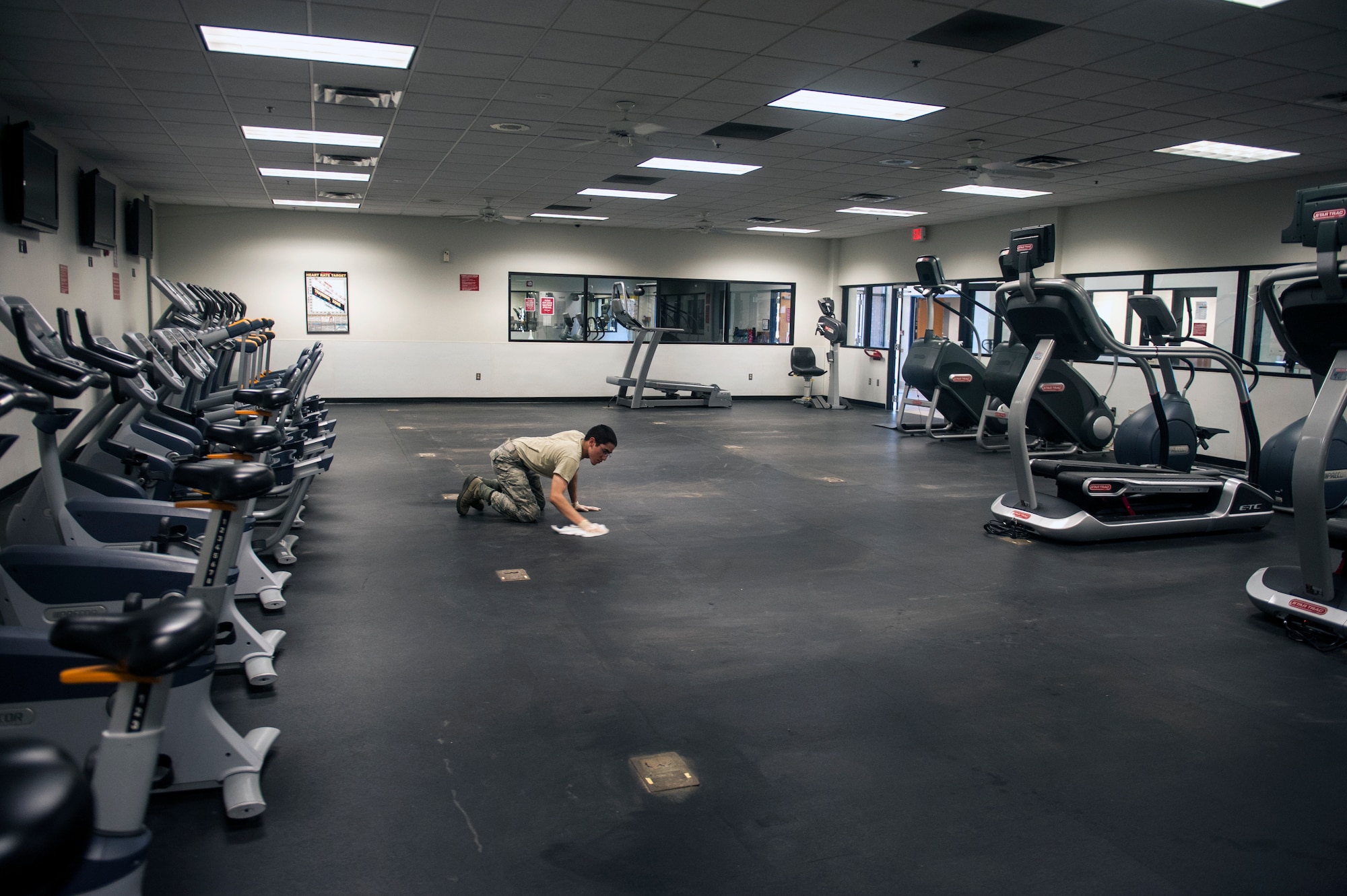 U.S. Air Force Airman Jonathan-Martin Webb, 23d Force Support Squadron services apprentice, cleans the cardio room floor Nov. 4, 2014, at Moody Air Force Base, Ga. Webb was cleaning the floor in preparation for a delivery of new cardio equipment. (U.S. Air Force photo by Senior Airman Jarrod Grammel/Released)
