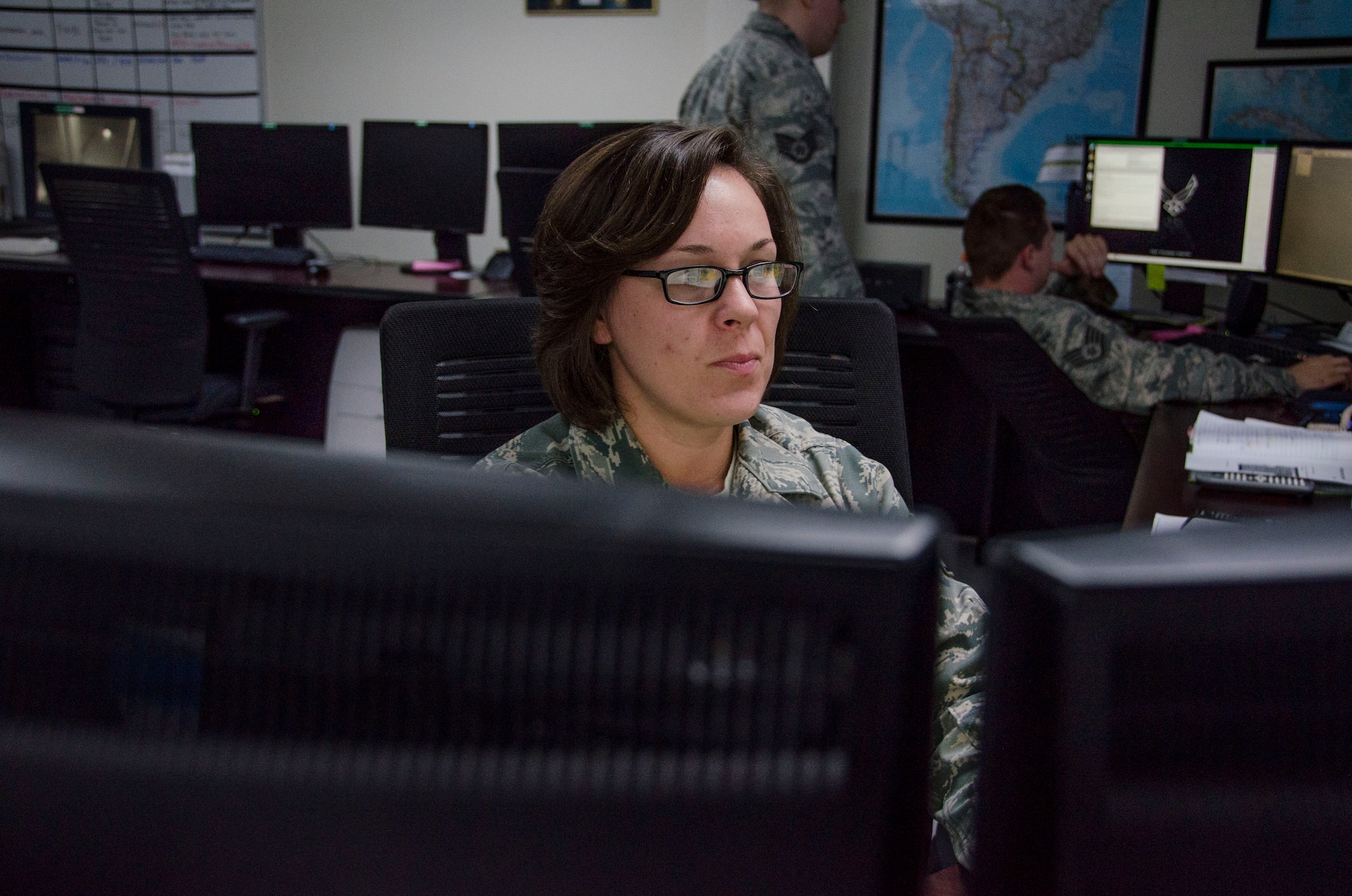 Staff Sgt. Toni Pierce, 612th Support Squadron Weather Forecaster, observes weather patterns at Davis-Monthan AFB, Ariz., Oct. 20, 2014. The weather forecasters of the 612th SPTS produce over 5,200 weather forecast products per month including, but not limited to, Flight Weather Mission Execution Forecasts, Terminal Aerodrome Forecasts and Graphical Depictions characterizing daily weather and flight hazards, as well as bulletin statements. (U.S. Air Force photo by Staff Sgt. Adam Grant/Released) 
