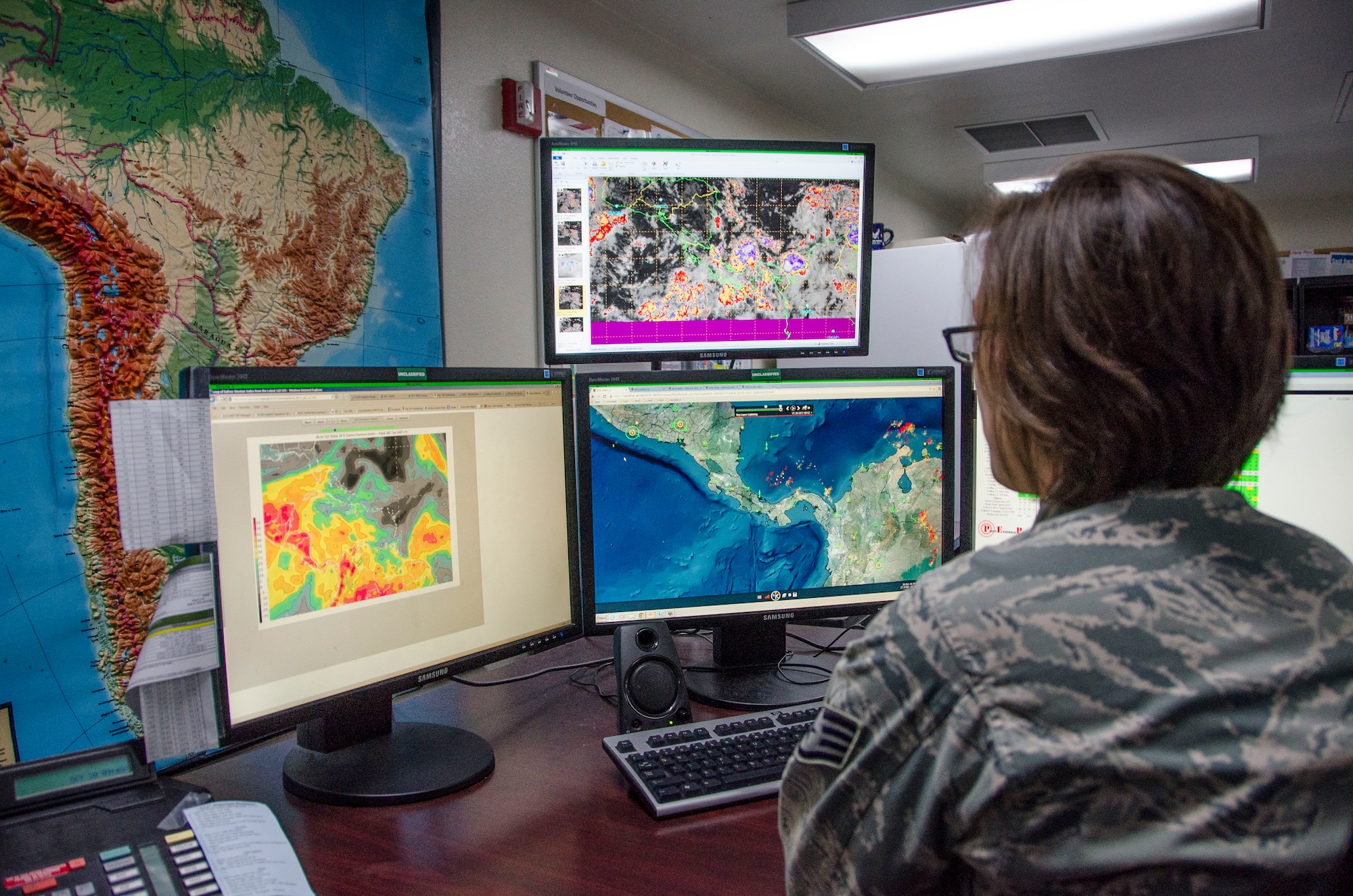 Staff Sgt. Toni Pierce, 612th Support Squadron Weather Forecaster, observes weather patterns at Davis-Monthan AFB, Ariz., Oct. 20, 2014. Pierce’s main focus is to ensure that areas around forward operating bases are aware of any inclement weather or the possibility of inclement weather. (U.S. Air Force photo by Staff Sgt. Adam Grant/Released) 