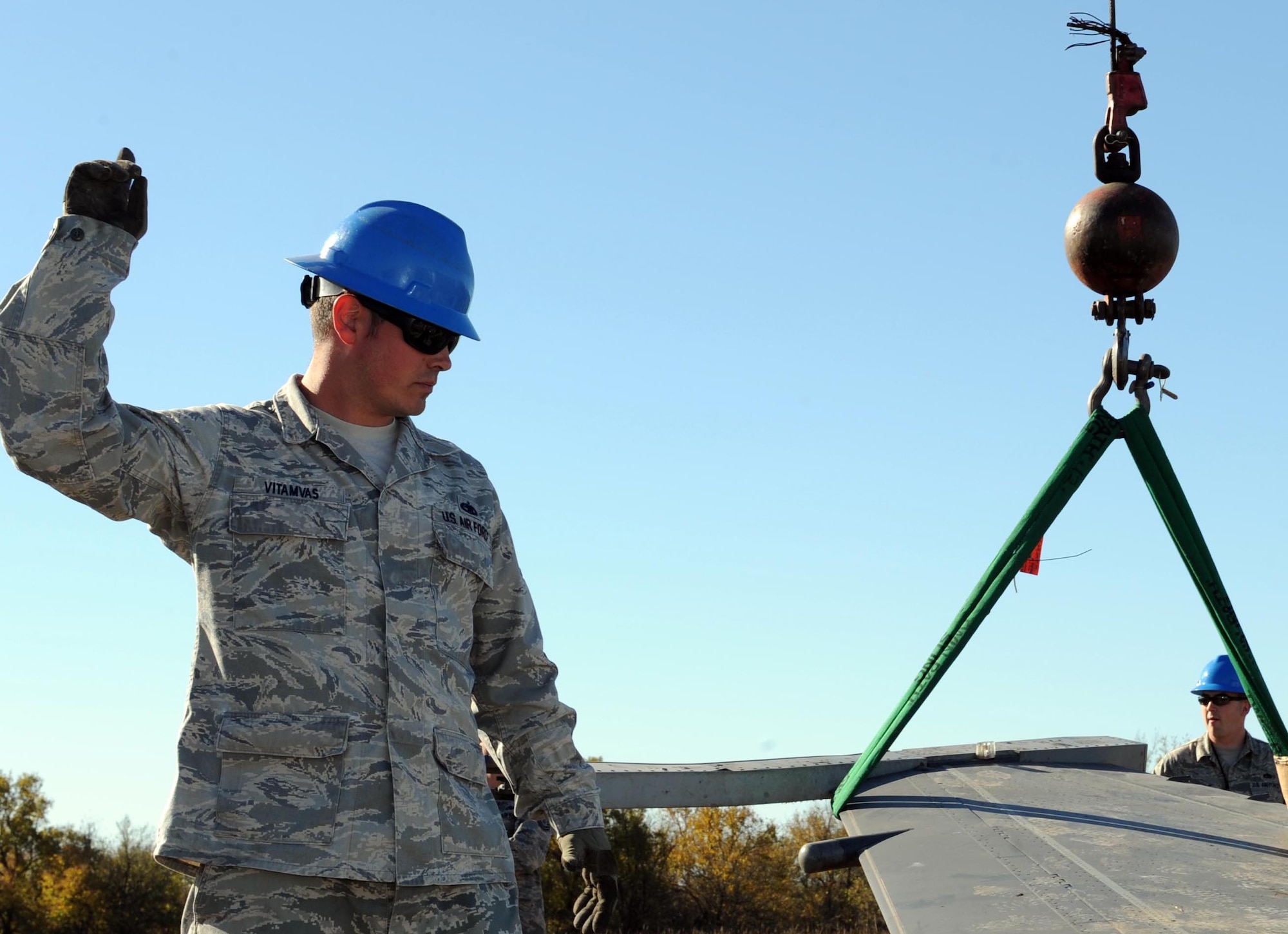Tech. Sgt. Patrick Vitamvas, 22nd Maintenance Squadron repairs and reclamations, orders an F-16 Fighting Falcon wing to be lifted, Oct. 29, 2014, near Moline, Kan. Vitamvas was part of McConnell Air Force Base’s Crash, Damaged, Disabled, Aircraft Recovery team helping the Oklahoma Air National Guard 138th Fighter Wing recover a downed aircraft. (U.S. Air Force photo/Airman 1st Class David Bernal Del Agua)