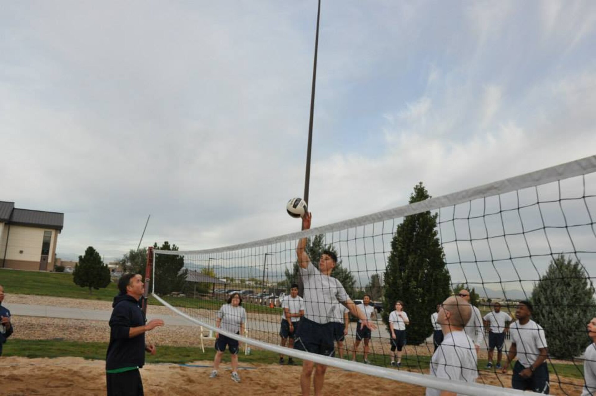 An Airman from the Buckley Air Force Base Airman Leadership School Class returns a volley during a match against the Buckley Chiefs and Shirts team Oct. 8, 2014, on Buckley Air Force Base, Colo. Three chief master sergeants and the first sergeant from the Air Reserve Personnel Center contributed to the Buckley Chiefs and Shirts team that put up a valiant effort during two matches. Chief Master Sgts. Ruthe Flores, Sean Strong and James Kirkley were a force to be reckoned as they pushed the Airmen to their limits. The matches were hard fought and closely officiated by ARPC's shirt, Senior Master Sgt. John Neeley. (U.S. Air Force photo/Tech. Sgt. Rob Hazelett)