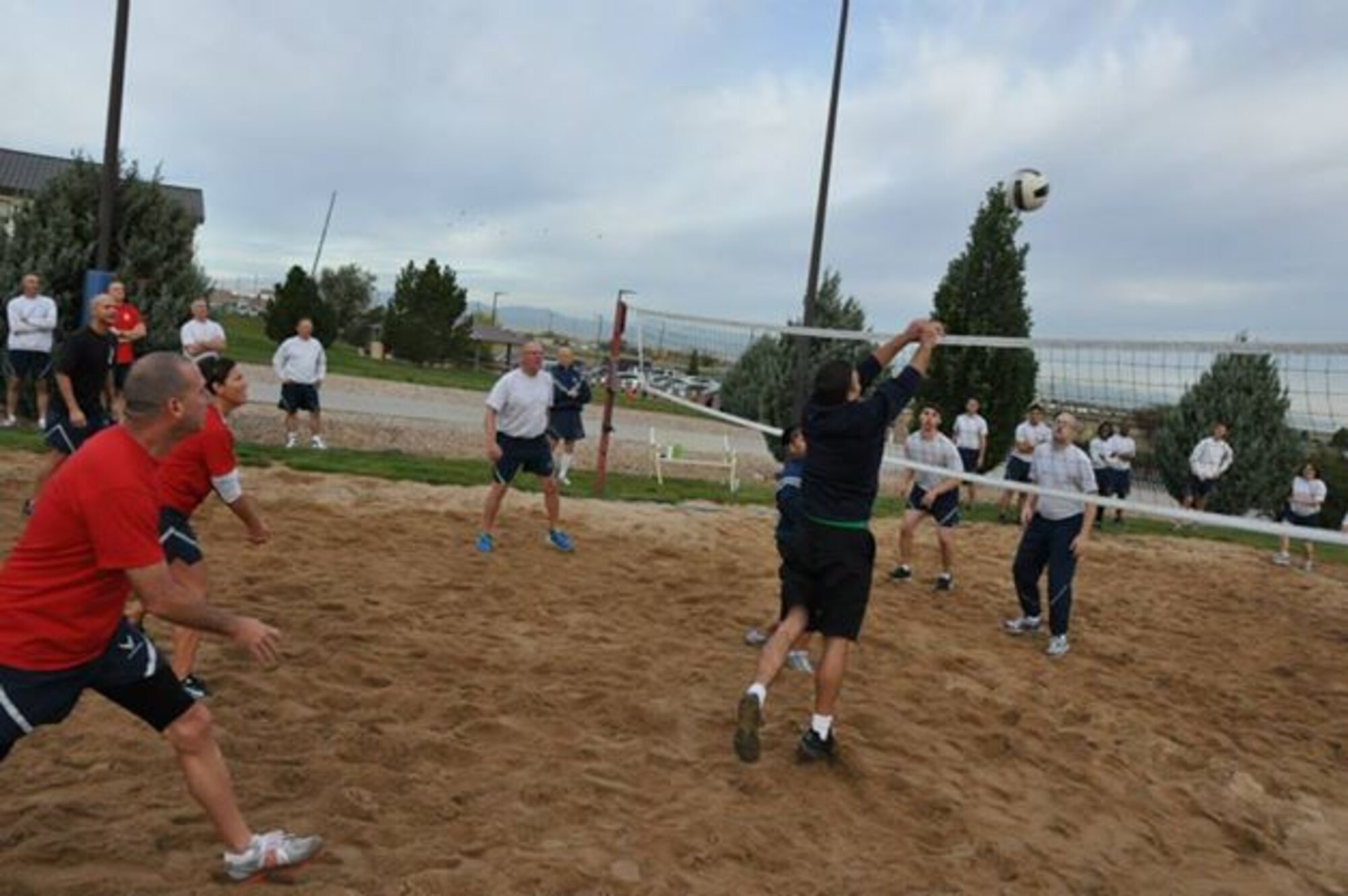 A chief master sergeant returns a volley to an airman during a match featuring the Buckley Chiefs and Shirts team versus Airmen from the Airman Leadership School Class held Oct. 8, 2014, on Buckley Air Force Base, Colo. Three chief master sergeants and the first sergeant from the Air Reserve Personnel Center contributed to the Buckley Chiefs team they were: Chief Master Sgts. Ruthe Flores, Sean Strong and James Kirkley.The matches closely officiated by ARPC's shirt, Senior Master Sgt John Neeley. (U.S. Air Force photo/Tech. Sgt. Rob Hazelett)