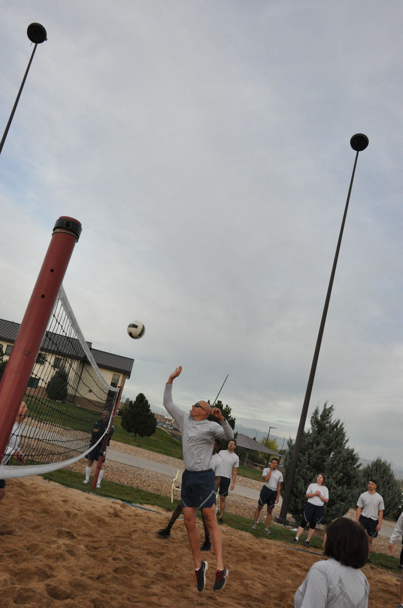 An Airman from the Buckley Air Force Base Airman Leadership School Class returns a volley during a match against the Buckley Chiefs and Shirts team Oct. 8, 2014, on Buckley Air Force Base, Colo. Three chief master sergeants and the first sergeant from the Air Reserve Personnel Center contributed to the Buckley Chiefs and Shirts team that put up a valiant effort during two matches. Chief Master Sgts. Ruthe Flores, Sean Strong and James Kirkley were a force to be reckoned as they pushed the Airmen to their limits. The matches were hard fought and closely officiated by ARPC's shirt, Senior Master Sgt. John Neeley. (U.S. Air Force photo/Tech. Sgt. Rob Hazelett)