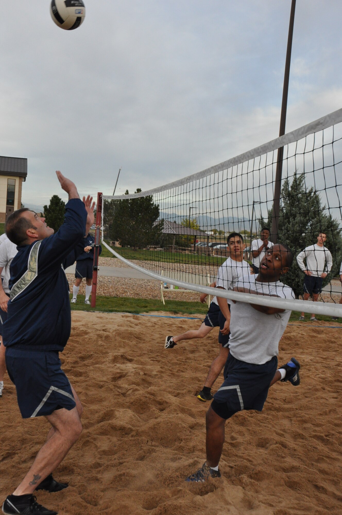 Chief Master Sgt. Scott Tierney, 566th Intelligence Squadron, prepares to return a volley during a match that featured the Buckley Chiefs and Shirts team versus the Airman Leadership School Class Oct. 8, 2014, on Buckley Air Force Base, Colo. Three chief master sergeants and the first sergeant from the Air Reserve Personnel Center contributed to the Buckley Chiefs and Shirts team that put up a valiant effort during two matches. Chief Master Sgts. Ruthe Flores, Sean Strong and James Kirkley were a force to be reckoned as they pushed the Airmen to their limits. The matches were hard fought and closely officiated by ARPC's shirt, Senior Master Sgt. John Neeley. (U.S. Air Force photo/Tech. Sgt. Rob Hazelett)