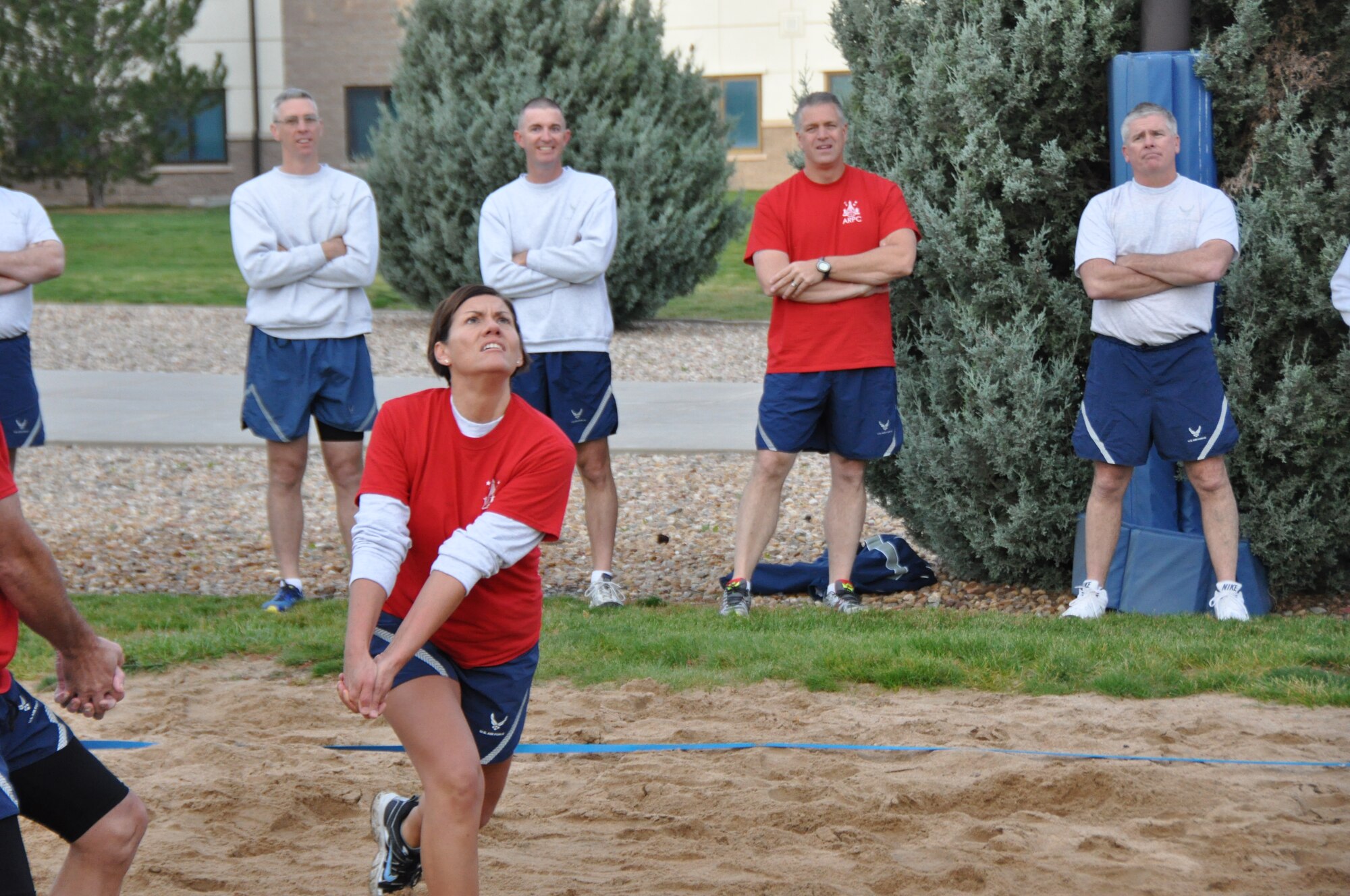 Chief Master Sgt. Ruthe Flores, Air Reserve Personnel Center command chief, waits on a serve during a match that featured the Buckley Chiefs and Shirts team versus the Airman Leadership School Class Oct. 8, 2014, on Buckley Air Force Base, Colo. Three chief master sergeants and the first sergeant from ARPC contributed to the Buckley Chiefs and Shirts team that put up a valiant effort during two matches. Flores, along with Chief Master Sgts. Sean Strong and James Kirkley were a force to be reckoned as they pushed the Airmen to their limits. The matches were hard fought and closely officiated by ARPC's shirt, Senior Master Sgt. John Neeley. (U.S. Air Force photo/Tech. Sgt. Rob Hazelett)