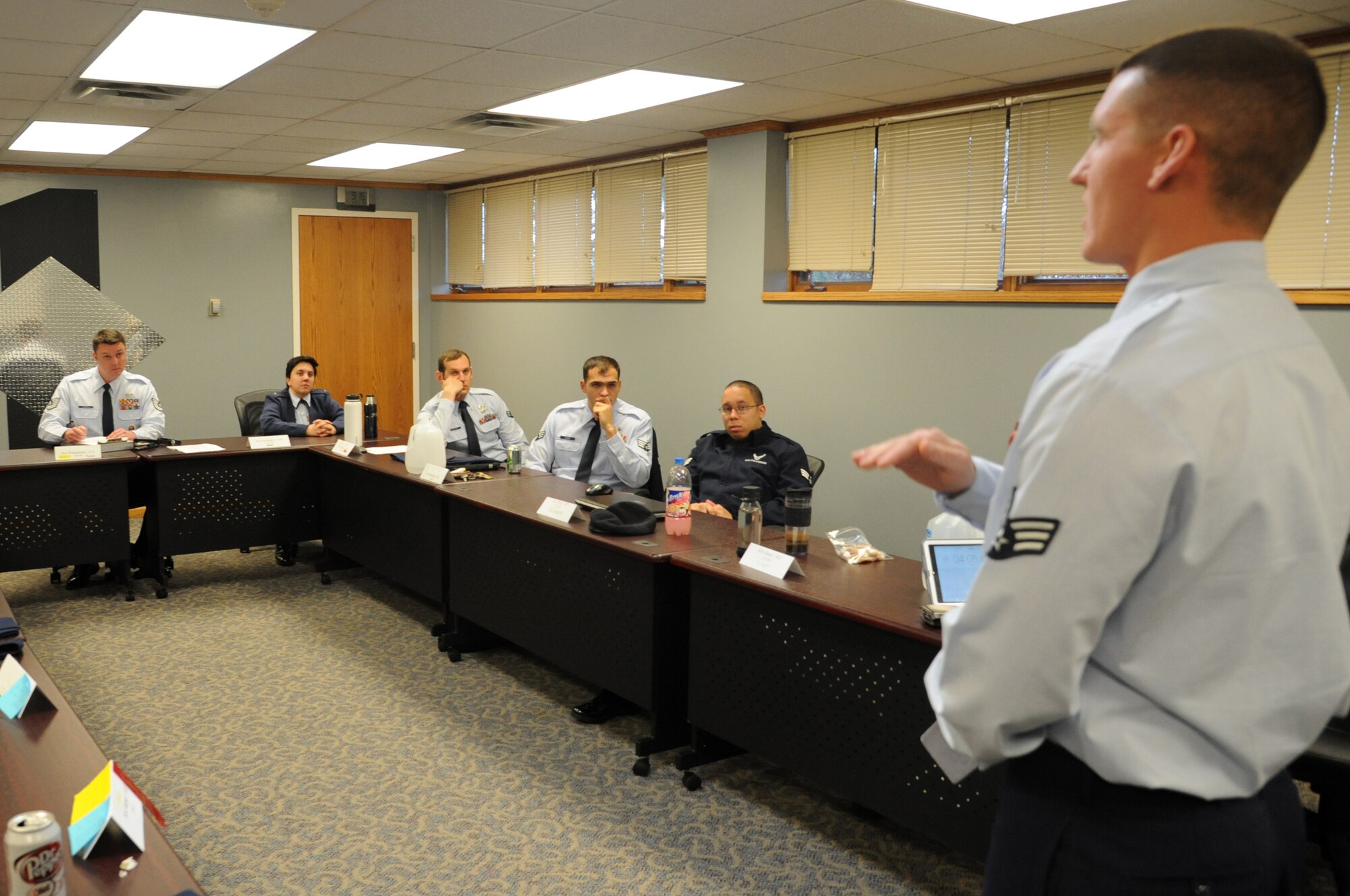 Tech. Sgt. James Richey Jr. (far left), Airman Leadership School senior instructor, listens as a student gives a presentation during classes at the Chief Master Sgt. Richard L. Etchberger ALS on Grand Forks Air Force Base, N.D., Nov. 5, 2014. The school hosts up to six classes per year containing 12-24 students who have been selected for promotion to the rank of staff sergeant. (U.S. Air Force photo/Staff Sgt. David Dobrydney)