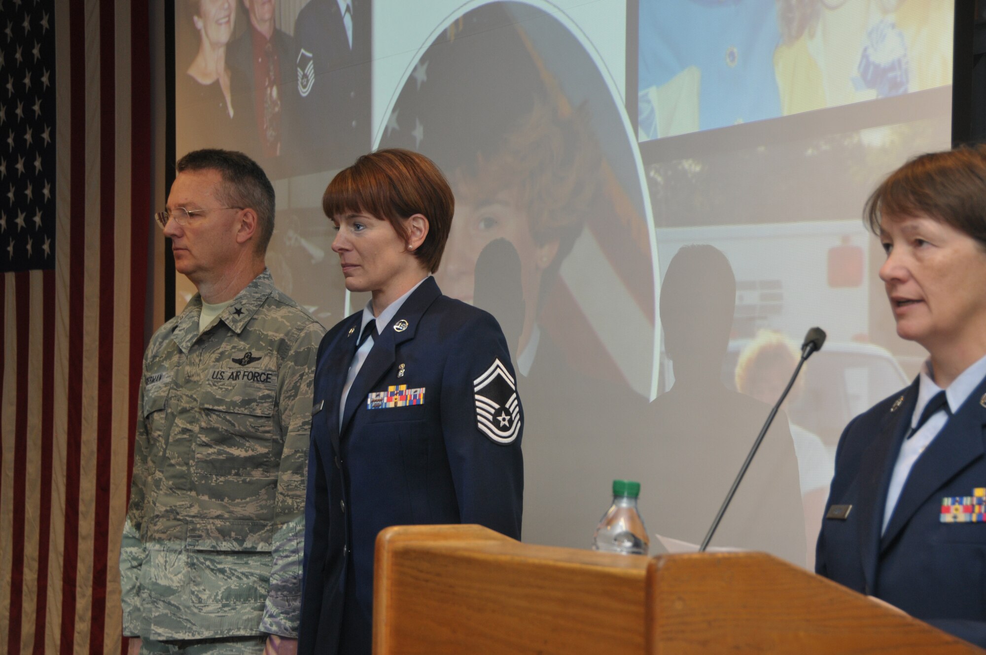 Master Sgt. Sally Baker (right), 109th Medical Group, reads the promotion order for newly promoted Chief Master Sgt. Jacqueline Sweet-McNeill during a ceremony with Brig. Gen. Anthony German, New York Air National Guard chief of staff, on Nov. 2, 2014. Sweet-McNeill is the 109th Medical Group superintendent. (U.S. Air National Guard photo by Tech. Sgt. Catharine Schmidt/Released)