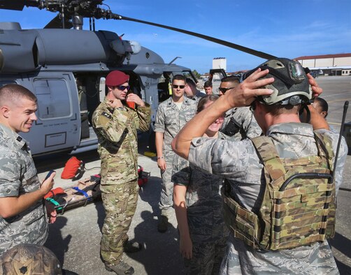An Air Force Reserve pararescueman from the 920th Rescue Wing at Patrick AFB, Fla., explains the details of pararescue equipment to a group of ROTC cadets from Embry-Riddle Aeronautical University. The cadets toured the wing's helicopter squadron, got an inside-out look at both types of 920th aircraft -- the HH-60G Pave Hawk helicopter and HC-130P/N King refueler -- and a look at a bit of life-saving gear at the operations support squadron. (U.S. Air Force photo/Master Sgt. Paul Flipse)