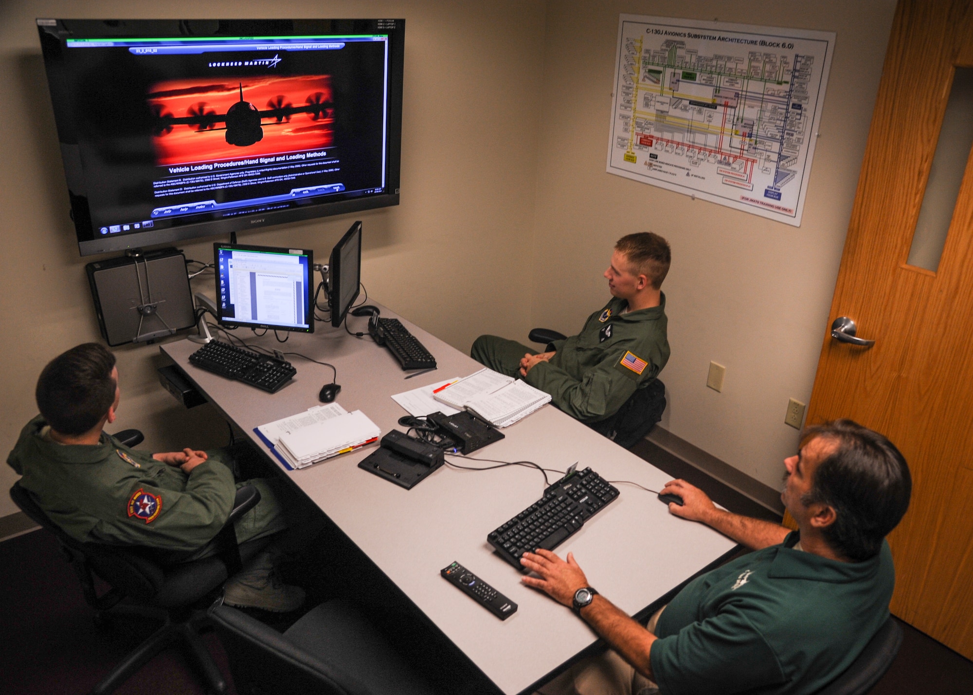 David Roussin, 714th Training Squadron C-130J maintenance and aircrew loadmaster training instructor (center), teaches a lesson to Airman 1st Class Noah Edmonds (left) and Airman 1st Class Ryan Firl (right), 714th TRS C-130J loadmaster students Oct. 29, 2014, at Little Rock Air Force Base, Ark. Initial C-130J loadmaster technical school training is approximately six months long. (U.S. Air Force photo by Airman 1st Class Harry Brexel)
