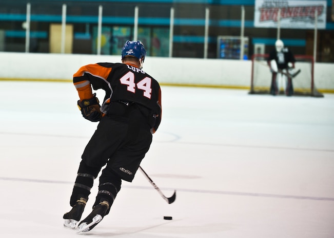 Johnny Lupo, an avid hockey player and fan, begins his course toward the opposition’s net during an overtime shootout of a game at the Fiesta Rancho Casino in Las Vegas Sept. 10, 2014. Lupo, a native of Wallingford, Conn., played hockey competitively throughout his childhood and now plays on two Las Vegas-area teams. Lupo is a captain in the U.S. Air Force and the commander of the 99th Force Support Squadron Military Personnel Flight at Nellis Air Force Base, Nev. (U.S. Air Force photo by Staff Sgt. Siuta B. Ika)