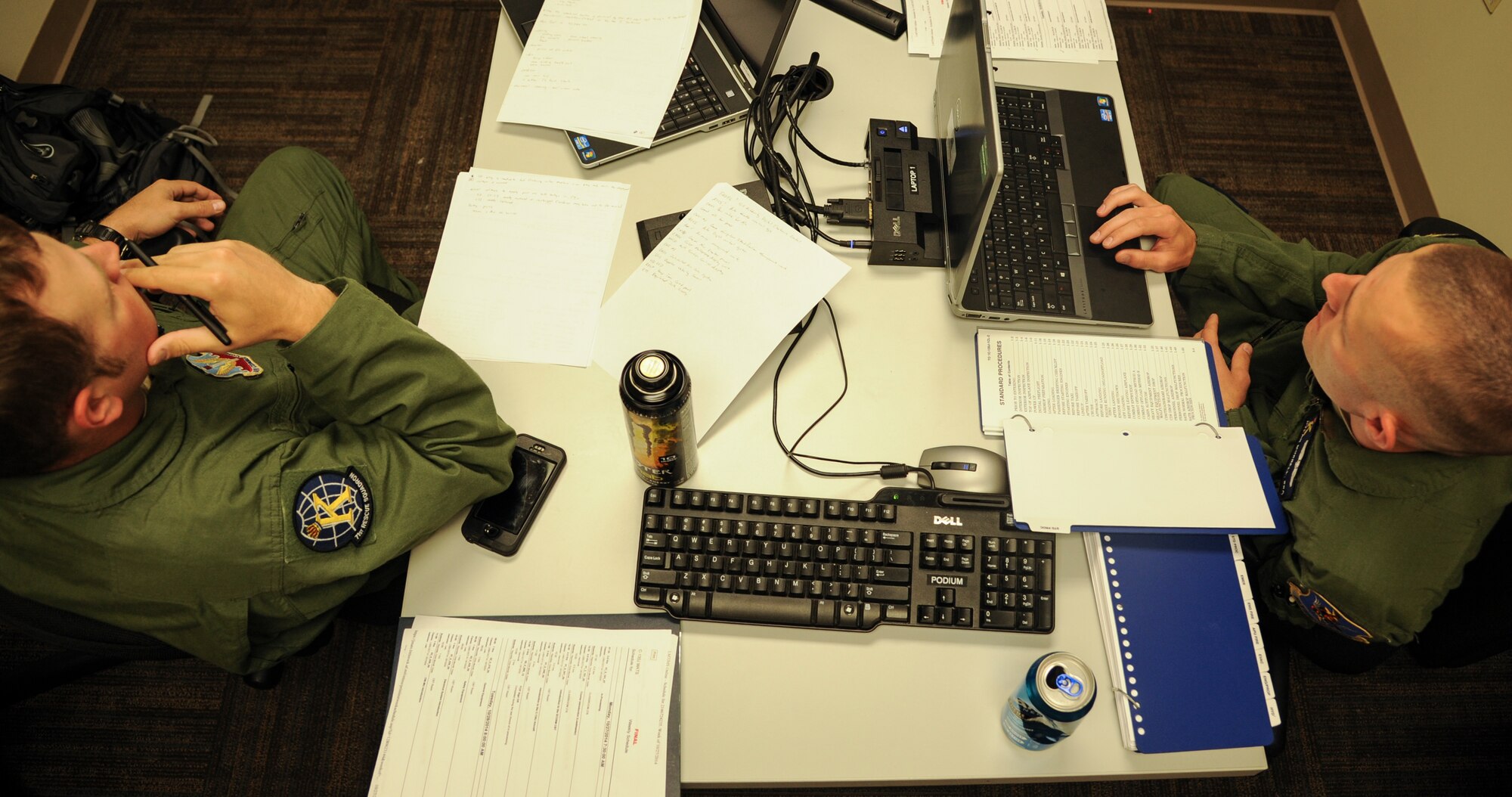 Staff Sgt. Christopher Reynolds (left) and Senior Airman Dylan Morrell (right), 71st Rescue Squadron loadmasters, review C-130J loadmaster course material Oct. 29, 2014, at Little Rock Air Force Base, Ark. Both Airmen from Moody AFB, Ga., are transitioning from the C-130H to the newer C-130J model. (U.S. Air Force photo by Airman 1st Class Harry Brexel)