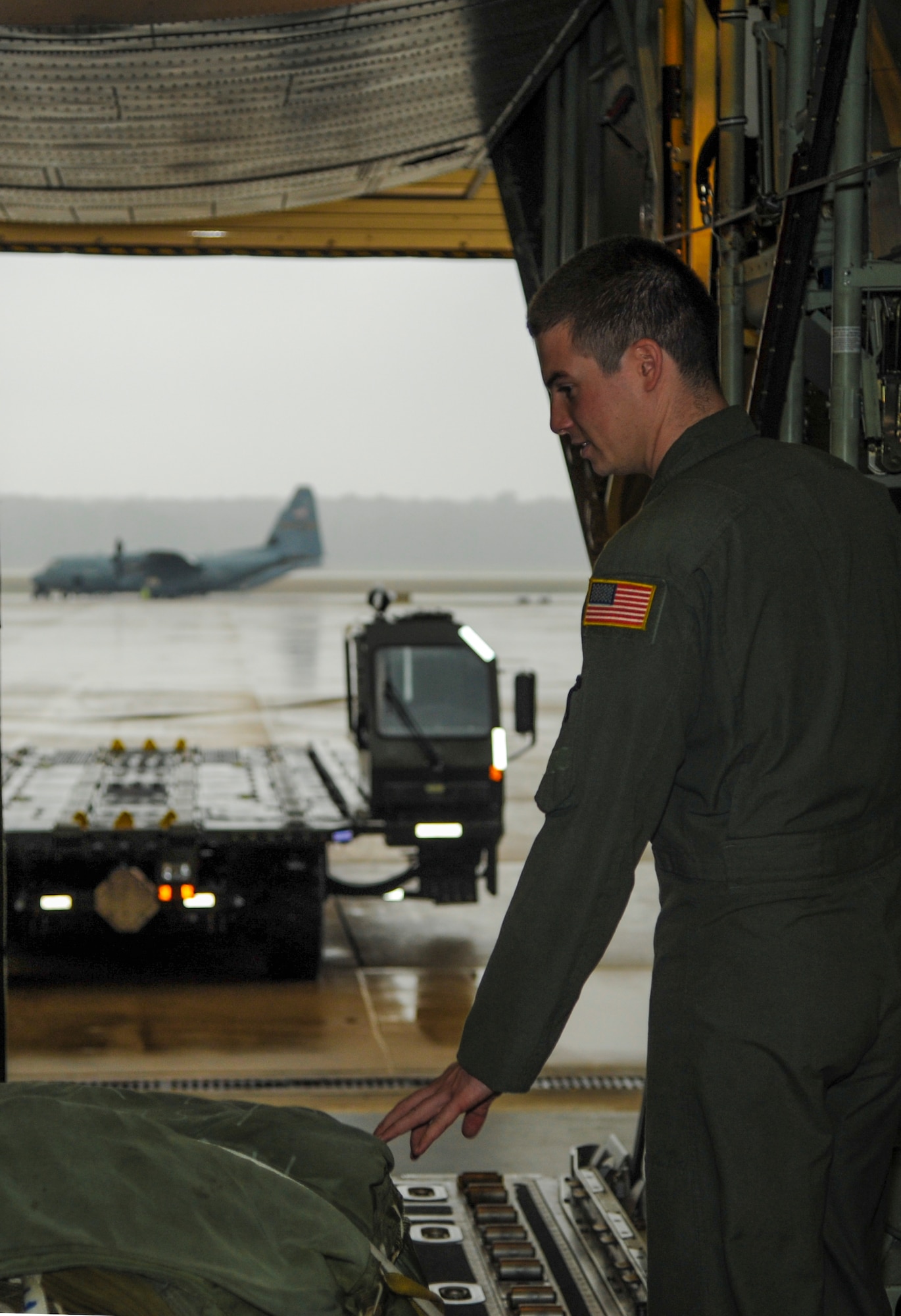 Airman 1st Class Frank Morgan, a 50th Airlift Squadron loadmaster, secures a container delivery system on a C-130J fuselage training unit Oct. 29, 2014, at Little Rock Air Force Base, Ark. Morgan is enrolled in loadmaster schooling at the 714th Training Squadron to prepare for his next assignment to the 39th Airlift Squadron at Dyess Air Force Base, Texas. (U.S. Air Force photo by Airman 1st Class Harry Brexel) 