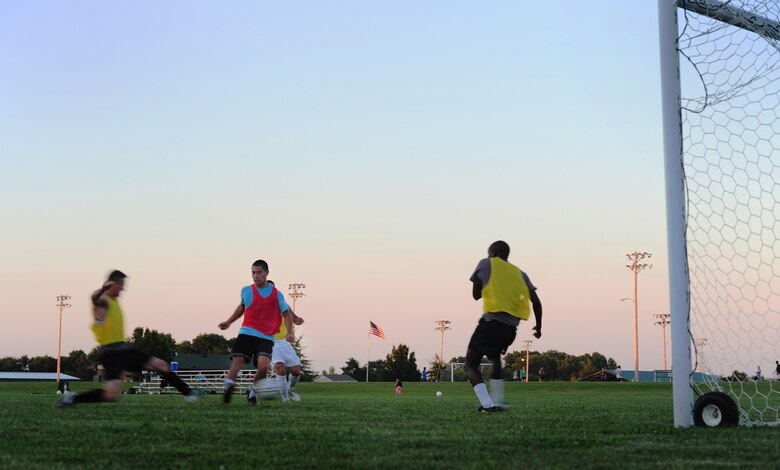 Players from the Sporting Whiteman varsity soccer team fight for possession of the ball during a scrimmage at Cloverdale Complex in Sedalia, Mo., Aug. 12, 2014. The team was preparing for the Defender’s Cup, an Armed Forces soccer tournament, which they scored sixth place in against 36 other teams. (U.S. Air Force photo by Staff Sgt. Nick Wilson/Released)