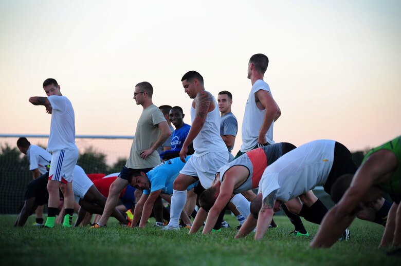 Members of the Sporting Whiteman soccer team take a stretch after a practice session at Cloverdale Complex in Sedalia, Mo., Aug. 12, 2014. The team was preparing for the Defender’s Cup, an Armed Forces soccer tournament, which they scored sixth place in against 36 other teams. (U.S. Air Force photo by Staff Sgt. Nick Wilson/Released)
