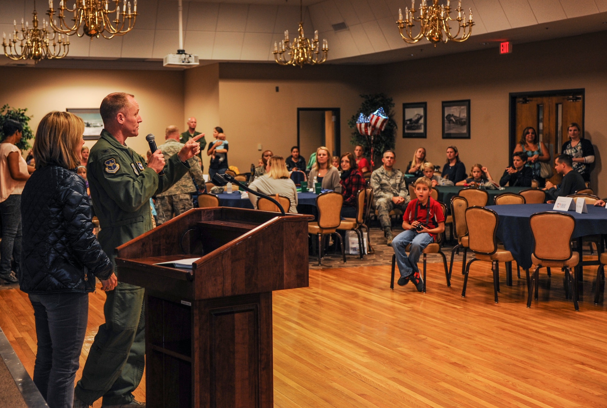 Col. Patrick Rhatigan, 19th Airlift Wing commander, along with his wife, Karen, kick off the Deployed Family Dinner Nov. 4, 2014, at Little Rock Air Force Base, Ark. The complementary dinner, sponsored by the Cabot Chamber of Commerce, was provided to the spouses and families of currently deployed Airmen. (U.S. Air Force photo by Airman 1st Class Harry Brexel)     