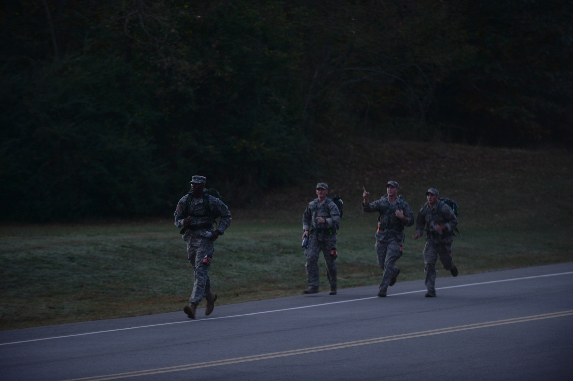 Team Little Rock and Camp Robinson members jog as they try to make time during the Norwegian Foot March Oct. 31, 2014, at Little Rock Air Force Base, Ark. The ruck sacks carried by each participant were required to weigh-in at least 25 pounds, but they could not be filled with items that could be replenished along their route such as water, sand or rocks. (U.S. Air Force photo by Senior Airman Cliffton Dolezal)