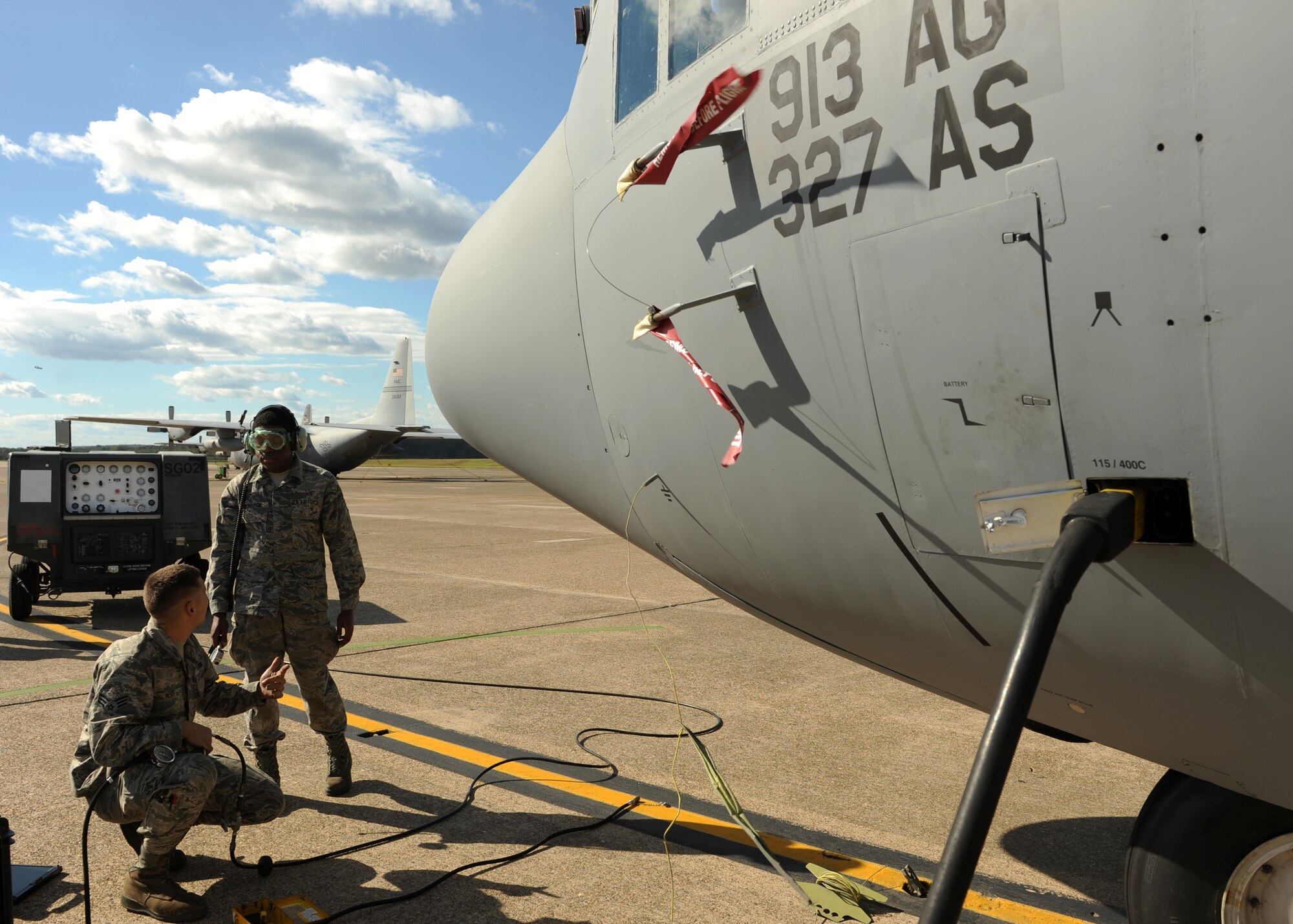 Senior Airman Andrew Head, a 913th Maintenance Squadron crew chief, along with Airman 1st Class Kendall Morrison, a 50th Airlift Squadron crew chief insure proper air pressure in the tires of a C-130H Oct. 14, 2014, at Little Rock Air Force Base, Ark. The tire pressure can differ depending on the cargo and the amount of fuel the aircraft is carrying. (U.S. Air Force photo by Airman 1st Class Scott Poe)
