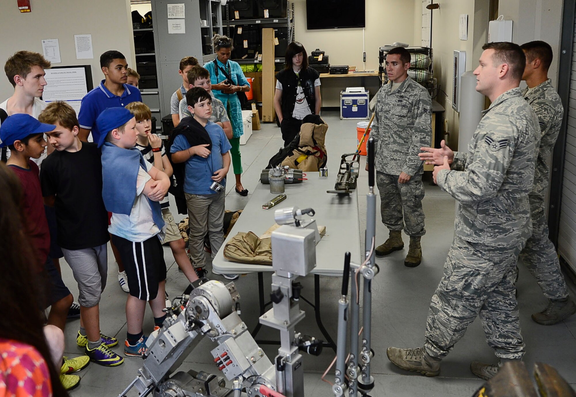 Airmen from the 6th Civil Engineer Squadron explain their specific Air Force specialty to a tour group visiting from the United Kingdom at MacDill Air Force Base, Fla., Nov. 4, 2014. The tour was organized for boys, aging from 11 to 17 years old, who have hemophilia, a rare blood disorder where the blood does not clot properly. (U.S. Air Force photo by Airman 1st Class Danielle Conde/Released)