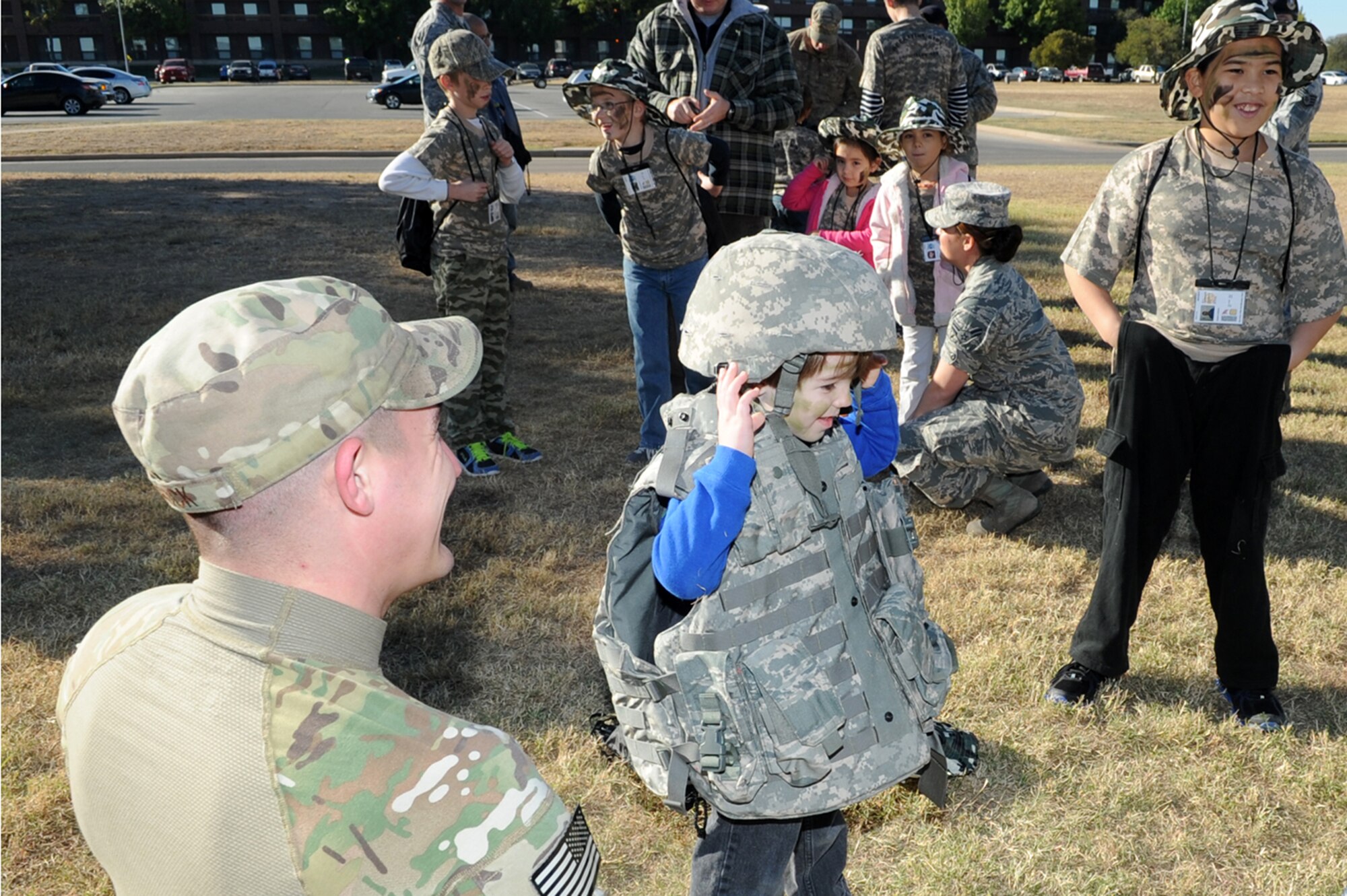 GOODFELLOW AIR FORCE BASE, Texas -- A youth tries on body armor during Operation Kids Investigating Deployment Services Nov. 1. The 17th Security Forces Squadron trained the youths for their mock deployment. (U.S. Air Force photo/ Staff Sgt. Laura R. McFarlane)