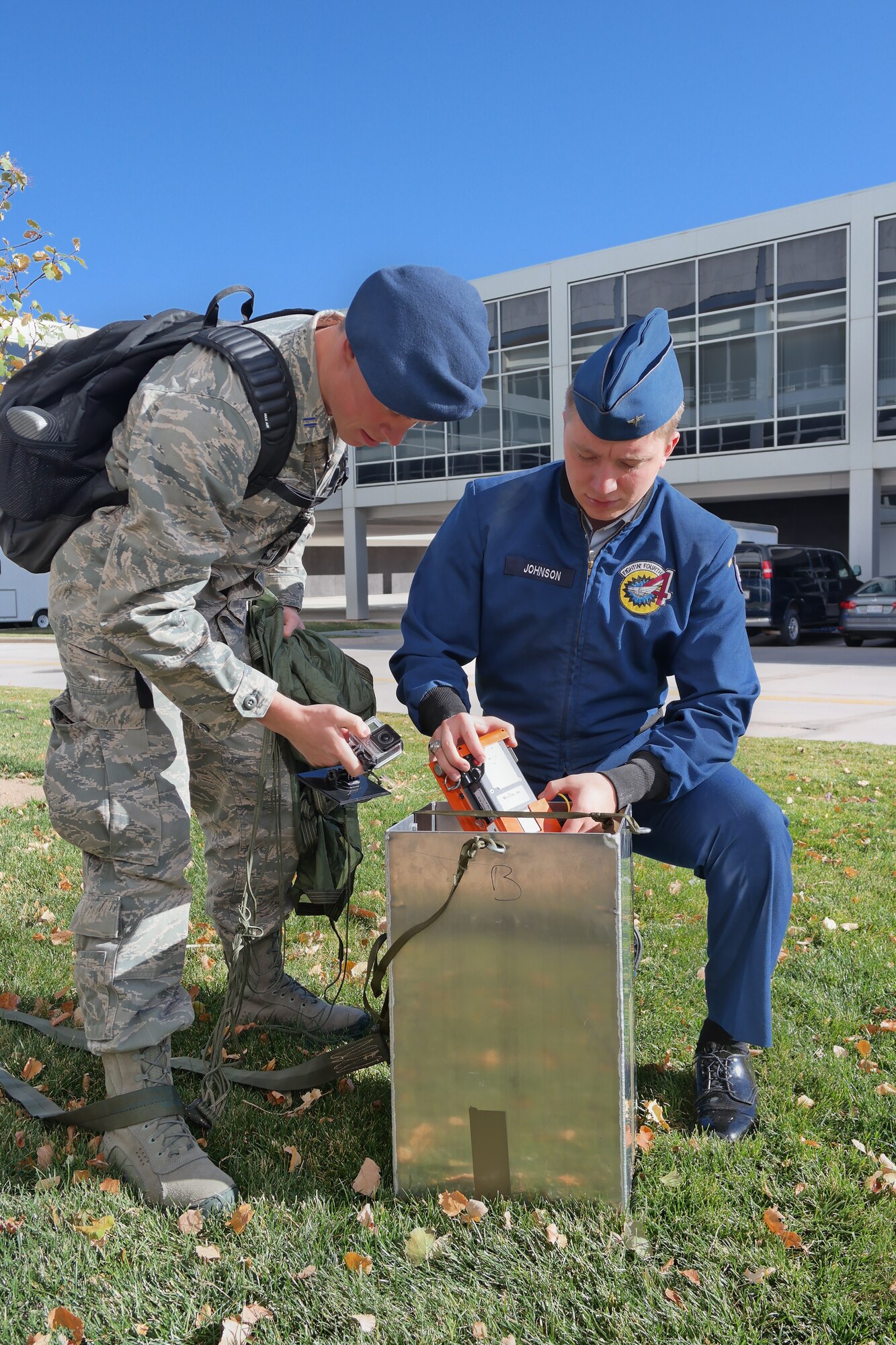 Academy Cadets 1st Class Max Johnson and Kyle Morse repack an airdrop practice model here created by a 2014 capstone project team working to mathematically model wind shear and speed to decrease the cost and increase the accuracy of combat zone airdrops. (U.S. Air Force photo) 