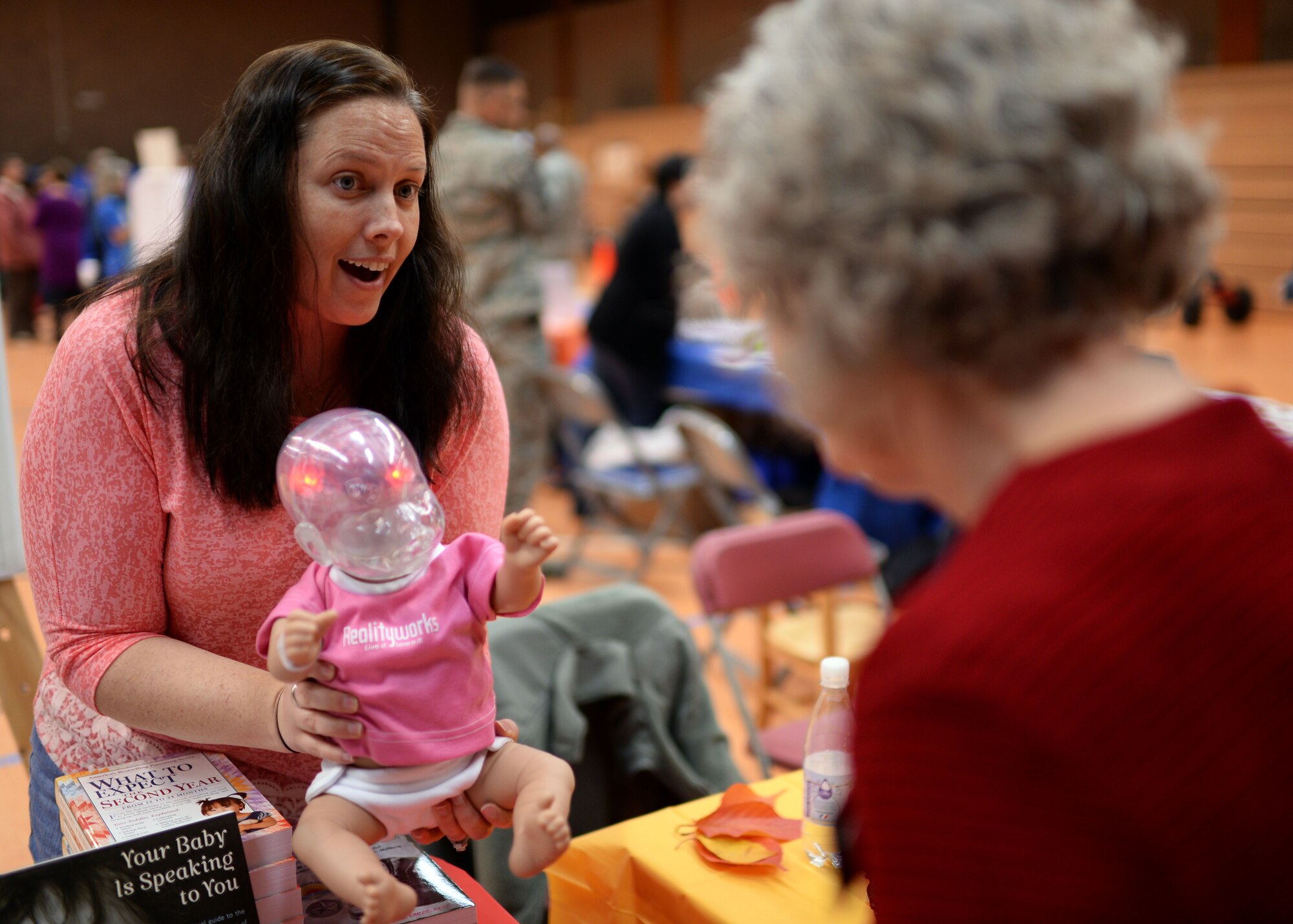 Tara Coenen, 52nd Medical Operations Squadron New Parent Support Program technician and registered nurse, demonstrates a RealityWorks shaken baby simulator during a 52nd Medical Group Fall Harvest Health Fair Nov. 5, 2014. The simulator lights up when shaken in three different areas of the brain, which represent how even one shake to a baby can permanently damage brain functions. (U.S. Air Force photo by Staff Sgt. Daryl Knee/Released)