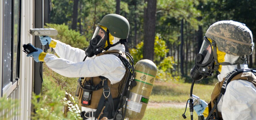Staff Sgt. Elizabeth McCulley, 307th Bomb Wing emergency manager, and Airman 1st Class Victoria Hammond, 2nd Civil Engineer Squadron emergency manager specialist, inspect a facility for radiological traces during an exercise on Barksdale Air Force Base, La., Oct. 29, 2014. Emergency management specialists inspect the outside of a facility for signs of radiation prior to entering the facility. (U.S. Air Force photo/Airman 1st Class Mozer O. Da Cunha)