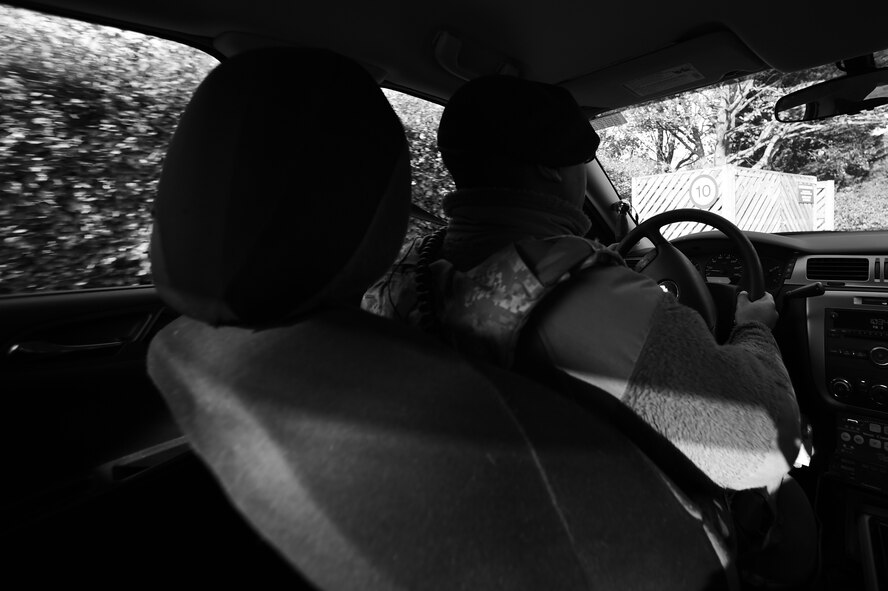 U.S. Air Force Airman 1st Class Lance Ryans, 422nd Security Forces Squadron patrolman, guides his cruiser through an area of on-base housing at RAF Croughton, United Kingdom, Nov. 5, 2014. For nearly two years, Ryans devoted himself to the protection and defense of the installation and the people on it. (U.S. Air Force photo by Staff Sgt. Jarad A. Denton/Released)