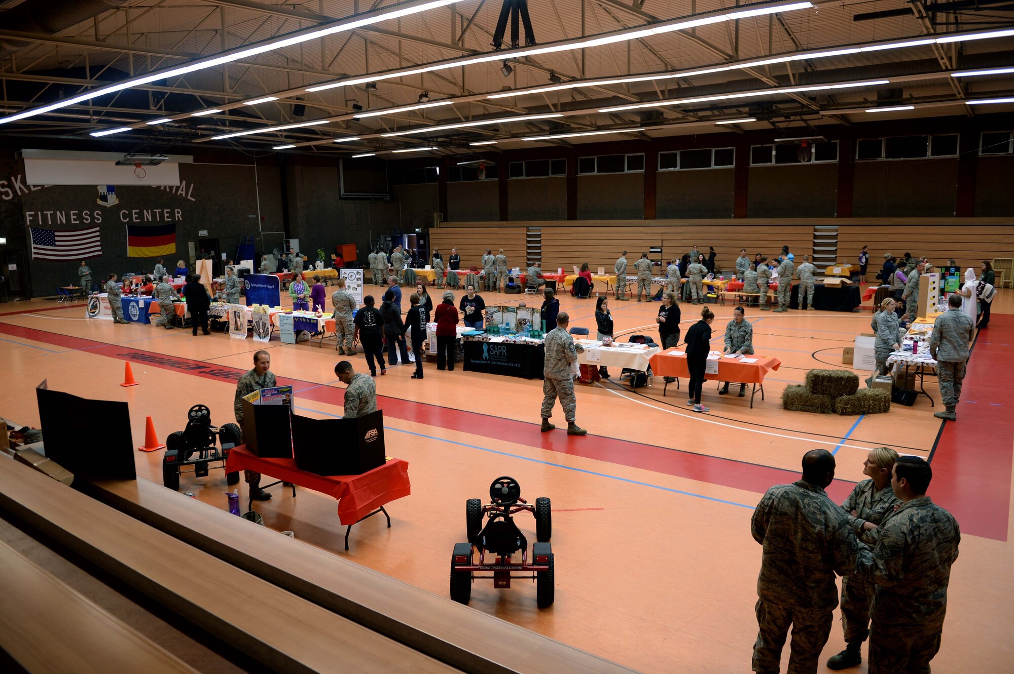 Spangdahlem Airmen and families interact with the 52nd Medical Group Airmen during the 2014 Fall Harvest Health Fair at the Skelton Memorial Fitness Center at Spangdahlem Air Base, Germany, Nov. 5, 2014. The medical group hosted the fair to promote health and fitness by providing free information, health checks and other services. (U.S. Air Force photo by Airman 1st Class Timothy Kim/Released)