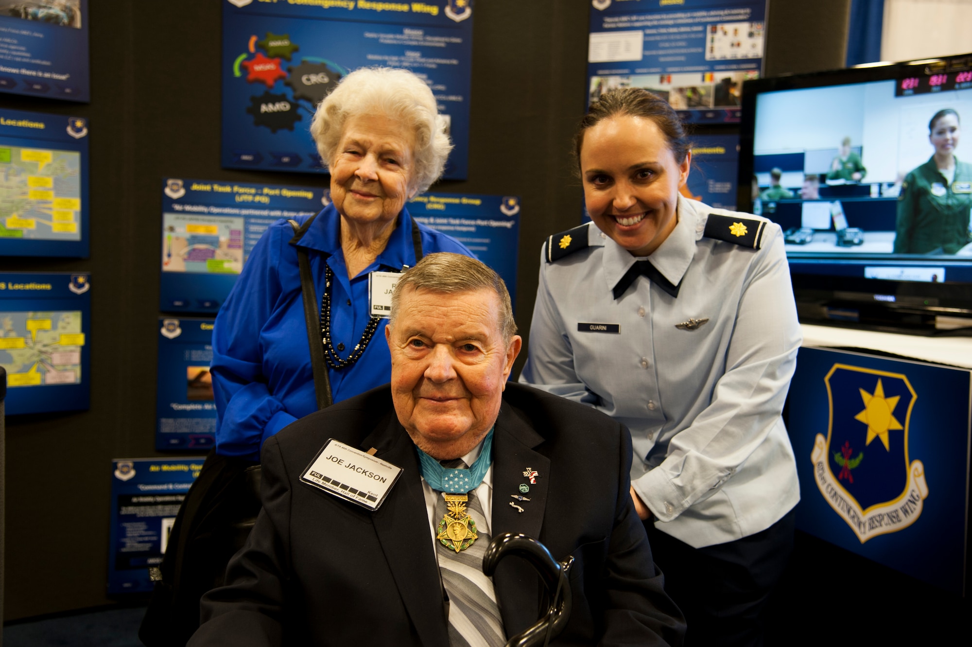 JOINT BASE MCGUIRE-DIX-LAKEHURST, N.J. –Medal of Honor recipient, U.S. Air Force retired Col. Joe Jackson and his wife Rose, shown here with Maj. Jessica Guarini, 817th Global Mobility Squadron, are honored at the 46th Annual Air Mobility Command’s Airlift/Tanker Association Symposium and Technological Exposition held Oct. 29 - Nov 3. Jackson is an Airlift/Tanker Association Hall of Fame Airman, inducted in 1997 for his actions during Vietnam when he rescued three isolated Combat Controllers from enemy fire. (U.S. Air Force photo/Staff Sgt. Destinie Berry/RELEASED)