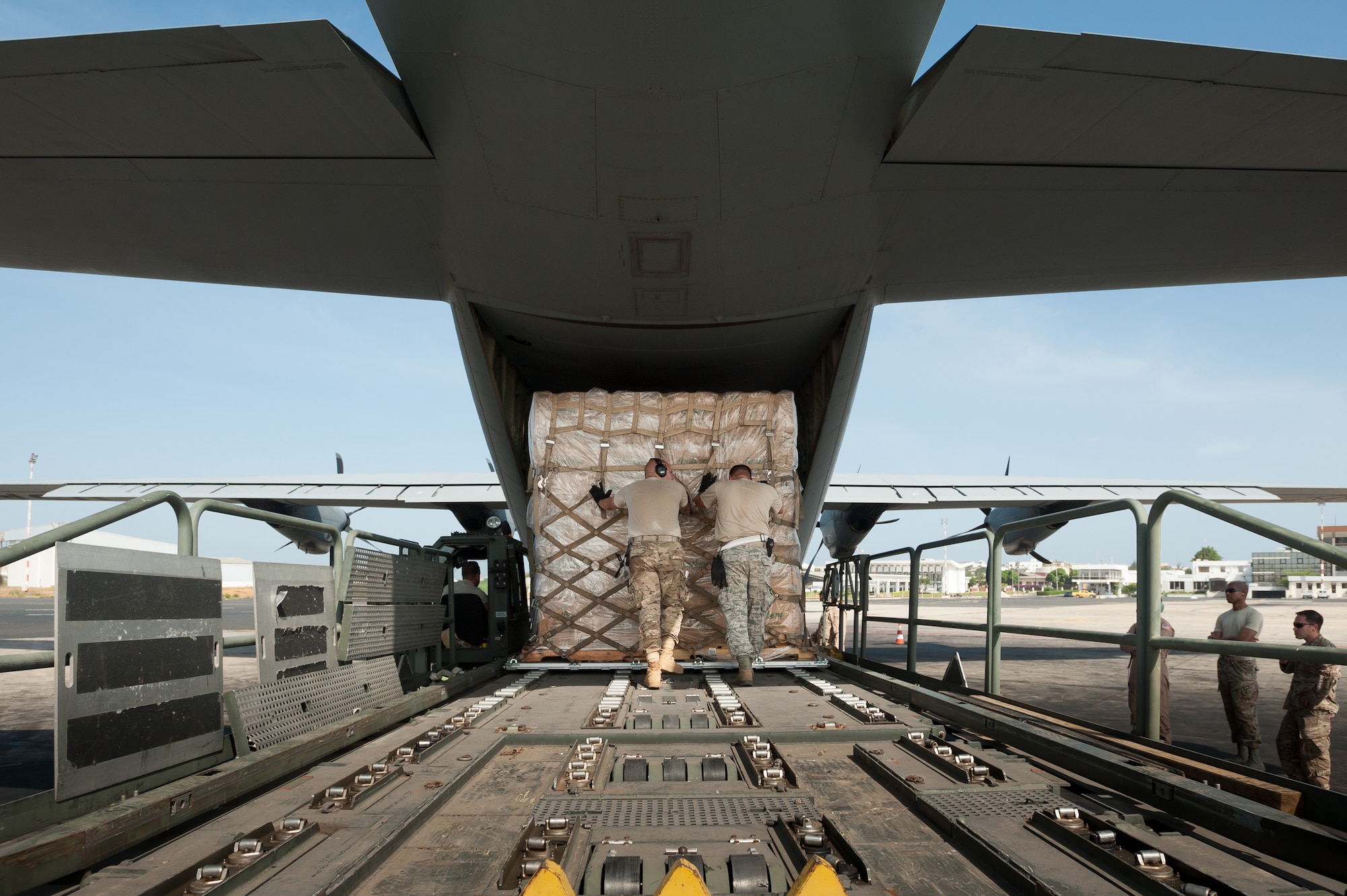 Aerial porters from the Kentucky Air National Guard’s 123rd Contingency Response Group push a pallet of cargo onto a C-130 aircraft from Dyess Air Force Base, Texas, at Léopold Sédar Senghor International Airport in Dakar, Senegal, Nov. 4, 2014. The Kentucky Airmen are operating an Aerial Port of Debarkation to funnel humanitarian aid to Liberia in support of Operation United Assistance, the U.S. Agency for International Development-led, whole-of-government effort to contain the Ebola virus outbreak in West Africa. (U.S. Air National Guard photo by Maj. Dale Greer)