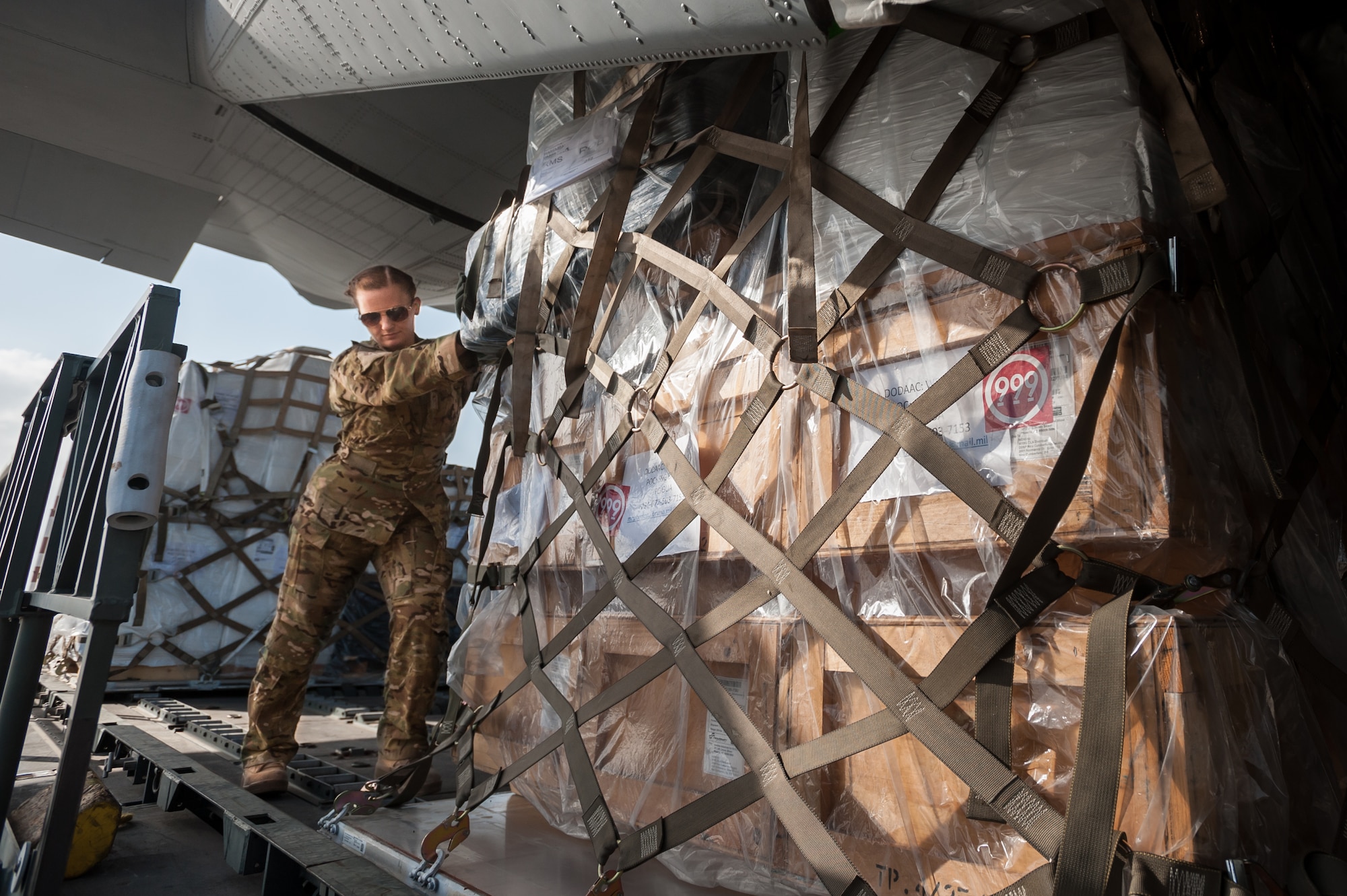 U.S. Air Force Airman 1st Class Teara Sapp, a loadmaster from the 317th Airlift Group at Dyess Air Force Base, Texas, loads a pallet of humanitarian aid and military supplies onto a U.S. Air Force C-130 aircraft at Léopold Sédar Senghor International Airport in Dakar, Senegal, Nov. 4, 2014. Sapp and 35 other Airmen from Dyess are deployed to Senegal as part of the 787th Air Expeditionary Squadron, which is flying cargo into Monrovia, Liberia, in support of Operation United Assistance, the U.S. Agency for International Development-led, whole-of-government effort to contain the Ebola virus outbreak in West Africa. (U.S. Air National Guard photo by Maj. Dale Greer)
