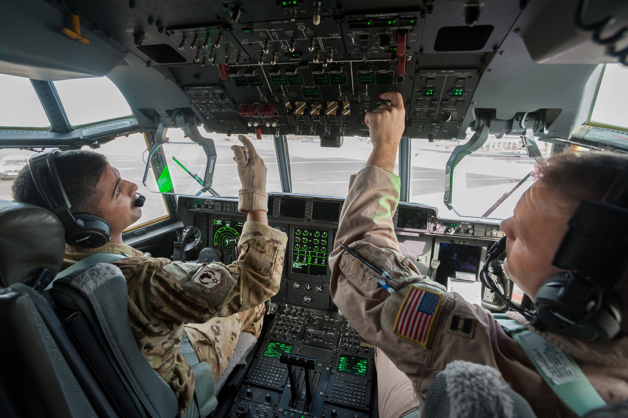 U.S. Air Force Capts. Vincent Levraea (left) and Jason Steinlicht, both pilots from the 317th Airlift Group at Dyess Air Force Base, Texas, conduct pre-flight checklists at Léopold Sédar Senghor International Airport in Dakar, Senegal, Nov. 4, 2014. The pilots are preparing to fly a sortie into Monrovia, Liberia, to deliver more than 8 tons of humanitarian aid and military supplies in support of Operation United Assistance, the U.S. Agency for International Development-led, whole-of-government effort to contain the Ebola virus outbreak in West Africa. (U.S. Air National Guard photo by Maj. Dale Greer)