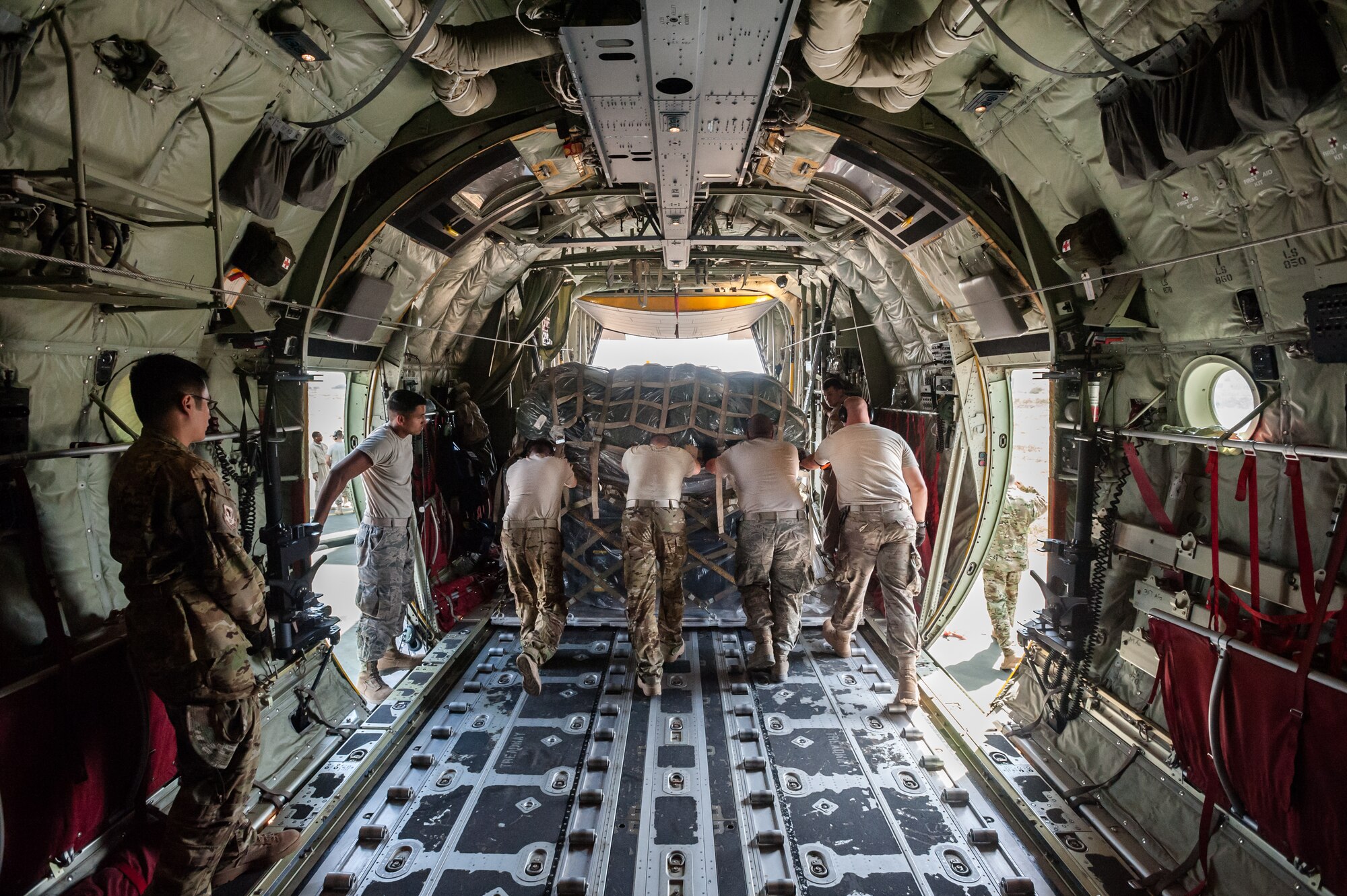 Aerial porters from the Kentucky Air National Guard’s 123rd Contingency Response Group push a pallet of cargo from the hold of a C-130 aircraft at Léopold Sédar Senghor International Airport in Dakar, Senegal, Nov. 3, 2014. The Kentucky Airmen are operating an Aerial Port of Debarkation to funnel humanitarian aid to Liberia in support of Operation United Assistance, the U.S. Agency for International Development-led, whole-of-government effort to contain the Ebola virus outbreak in West Africa. (U.S. Air National Guard photo by Maj. Dale Greer)