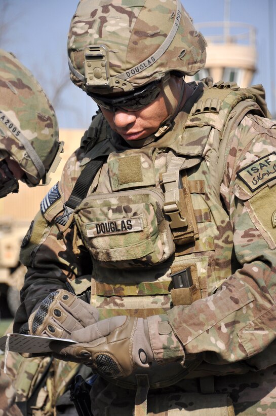 U.S. Army Spc. Marion A. Douglas completes a tactical combat casualty card during a training exercise in Kabul, Afghanistan, Oct. 24, 2014. Douglas is a gunner assigned to the Oregon Army National Guard's Company A, 2nd Battalion, 162nd Infantry, 41st Infantry Brigade Combat Team.