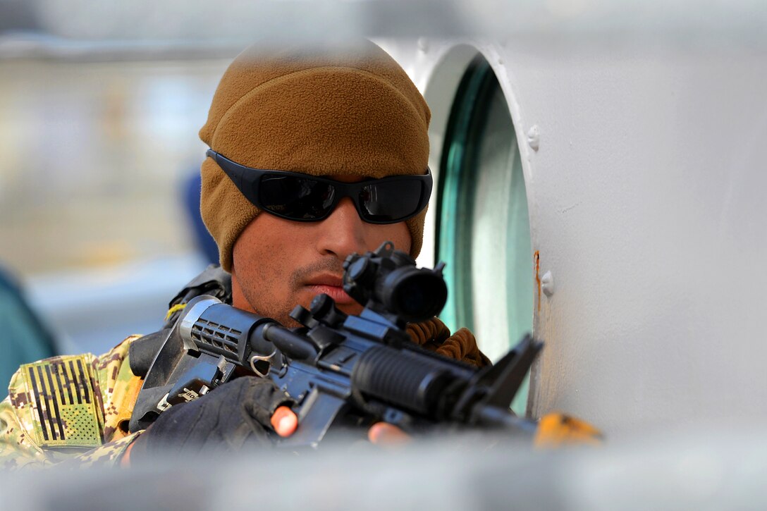 Navy Petty Officer 2nd Class Keith Shell participates in a visit, board, search and seizure exercise aboard the Navy training boat USNS Hunter during the Bold Alligator exercise in Morehead City, N.C., Nov. 2, 2014. Shell is a gunner's mate assigned to Coastal Riverine Squadron 4.