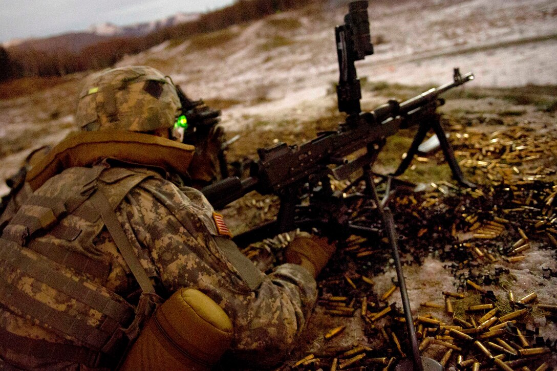 A soldier prepares to reload his M240B machine gun during a live-fire exercise on Joint Base Elmendorf-Richardson, Alaska, Nov. 4, 2014.  
