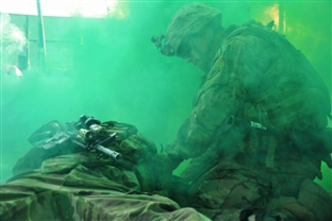 U.S. Army Spc. Guillermo D. Carias, right, places a tourniquet on the left arm of a fellow soldier during a training exercise in Kabul, Afghanistan, Oct. 24, 2014. Carias is a driver assigned to the Oregon Army National Guard's Company A, 2nd Battalion, 162nd Infantry, 41st Infantry Brigade Combat Team. 
