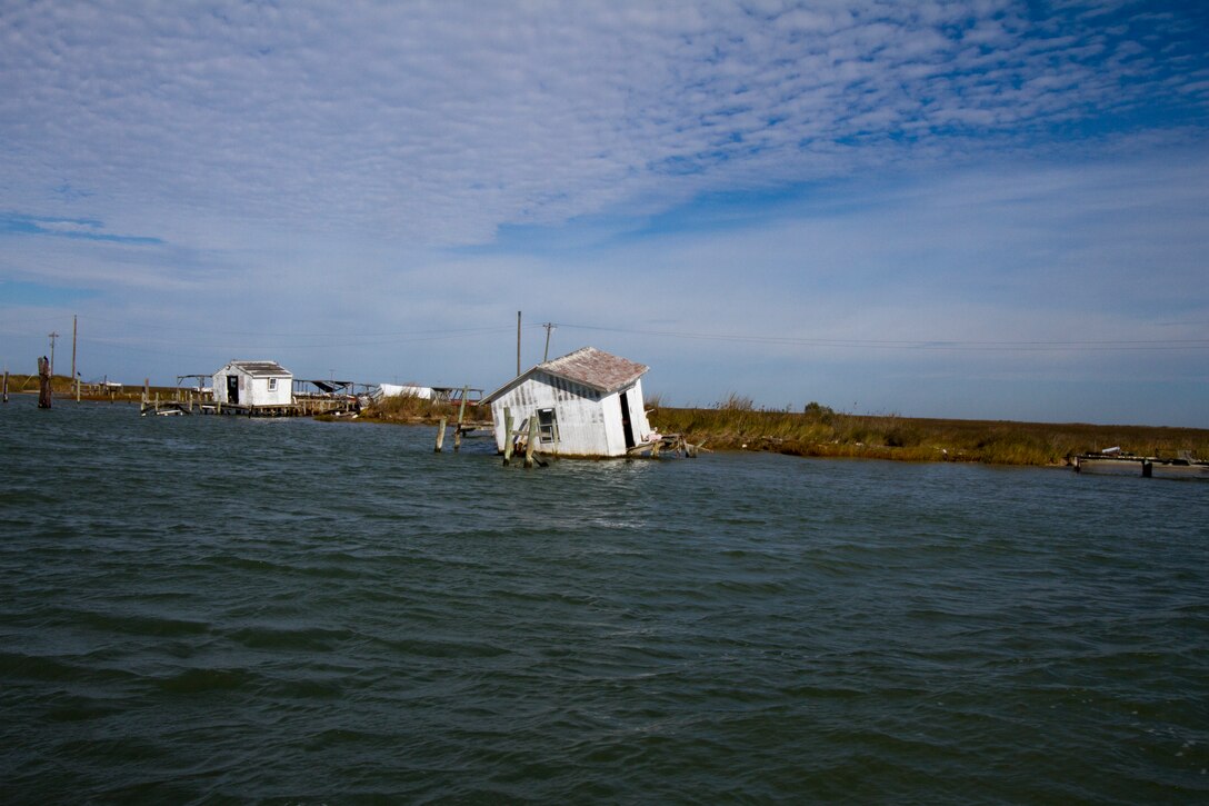 TANGIER, Va. -- A damaged shack that once housed equipment used by watermen on Tangier Island sits empty along the harbor here November 3, 2014. The Norfolk District, U.S. Army Corps of Engineers is working on a breakwater that will help protect the boats and shacks in the harbor from damaging wave attack during coastal storms.