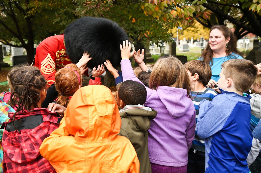 Students from the Washington Day School feel the bearskin of Drum Major Master Sgt. Duane F. King after the Marine Band performed a gravesite ceremony honoring the 160th anniversary of its 17th Director John Philip Sousa on Nov. 6, 2014, at Congressional Cemetery in Washington, D.C. (U.S. Marine Corps photo by Staff Sgt. Brian Rust/released)