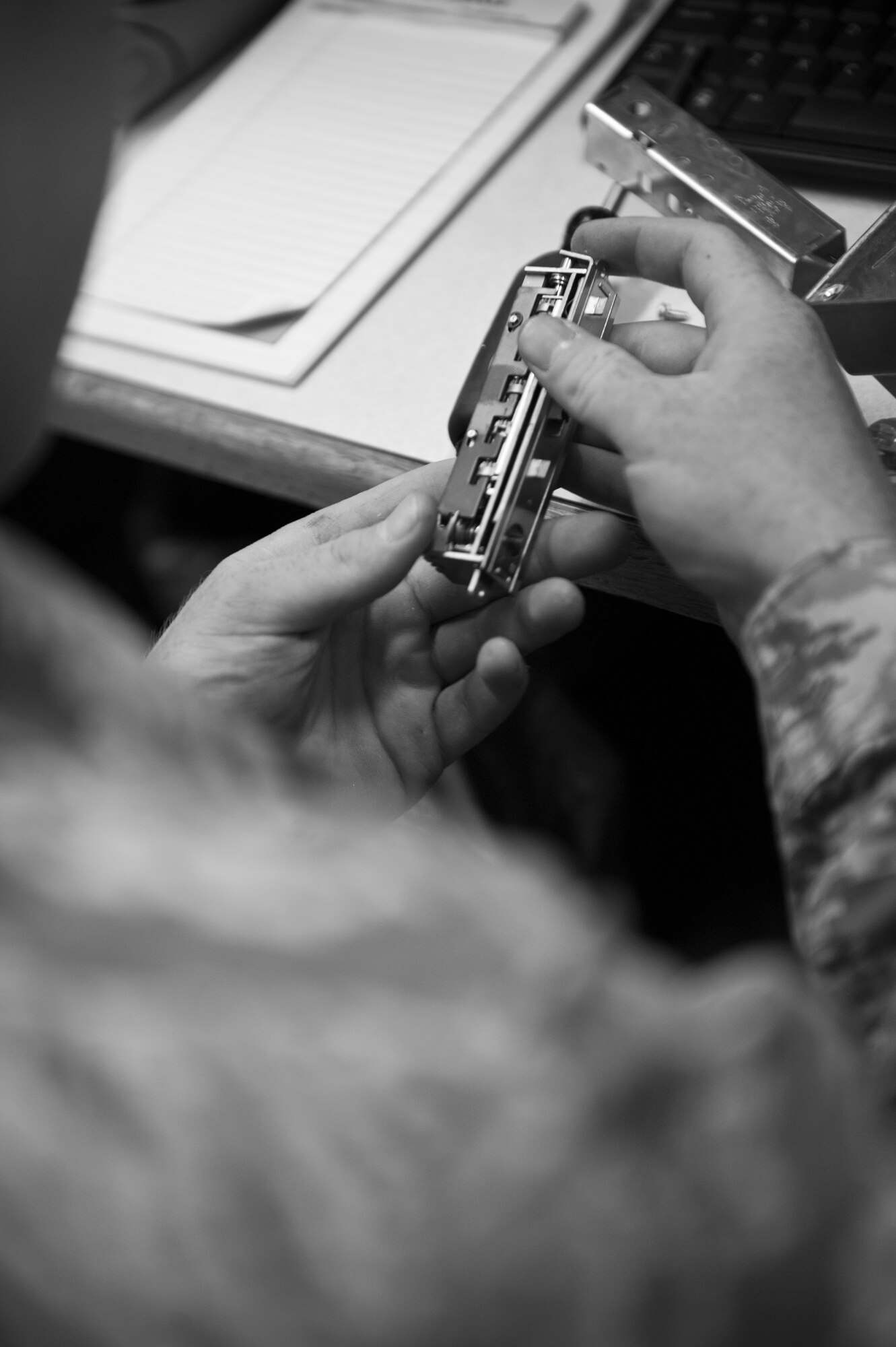 Airman 1st Class Andrew Conner, 1st Special Operations Civil Engineer structural apprentice, works on a cipher lock at the locksmith shop on Hurlburt Field, Fla., Nov. 6, 2014. Conner defeated the lock in order to change the combination. (U.S. Air Force photo/Senior Airman Krystal M. Garrett) 