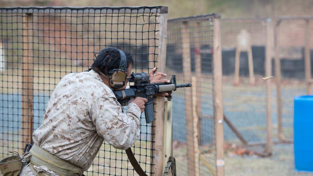 A competitor fires a M27 Infantry Automatic Rifle at targets during the 4th Annual Quantico Combat Shooting Match Oct. 29, at Marine Corps Base Quantico. The competition was comprised of varying sections, challenging the competitors in their marksmanship and maneuverability through a urban environment.