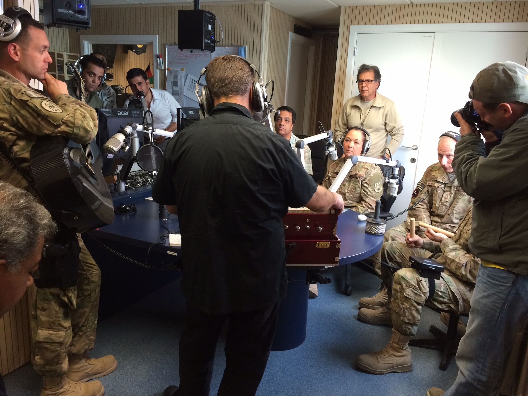 Staff Sgt. Alex Nikiforoff, Master Sgt. Michele Harris and Master Sgt.Steve Przyzycki of the U.S. Air Force Central Command Band join Afghan musicians Satar Nangially and Sayed Momayoun Alimi along with an interpreter to answer calls from Afghan listeners in Kabul, Afghanistan on Oct 13, 2014. Touch 'N Go  made history as the first ensemble of western musicians to ever be featured on Bayan Radio, the second largest radio station in the country. (Courtesy photo)
